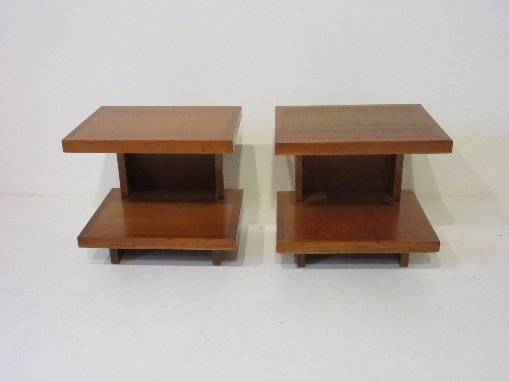 An important and rare pair of Frank Lloyd Wright side tables made for the Levin house in Kalamazoo Michigan. From the first house built in Parkwyn Village a planned community of Usonian homes formed by a group of forward thinking employees of the