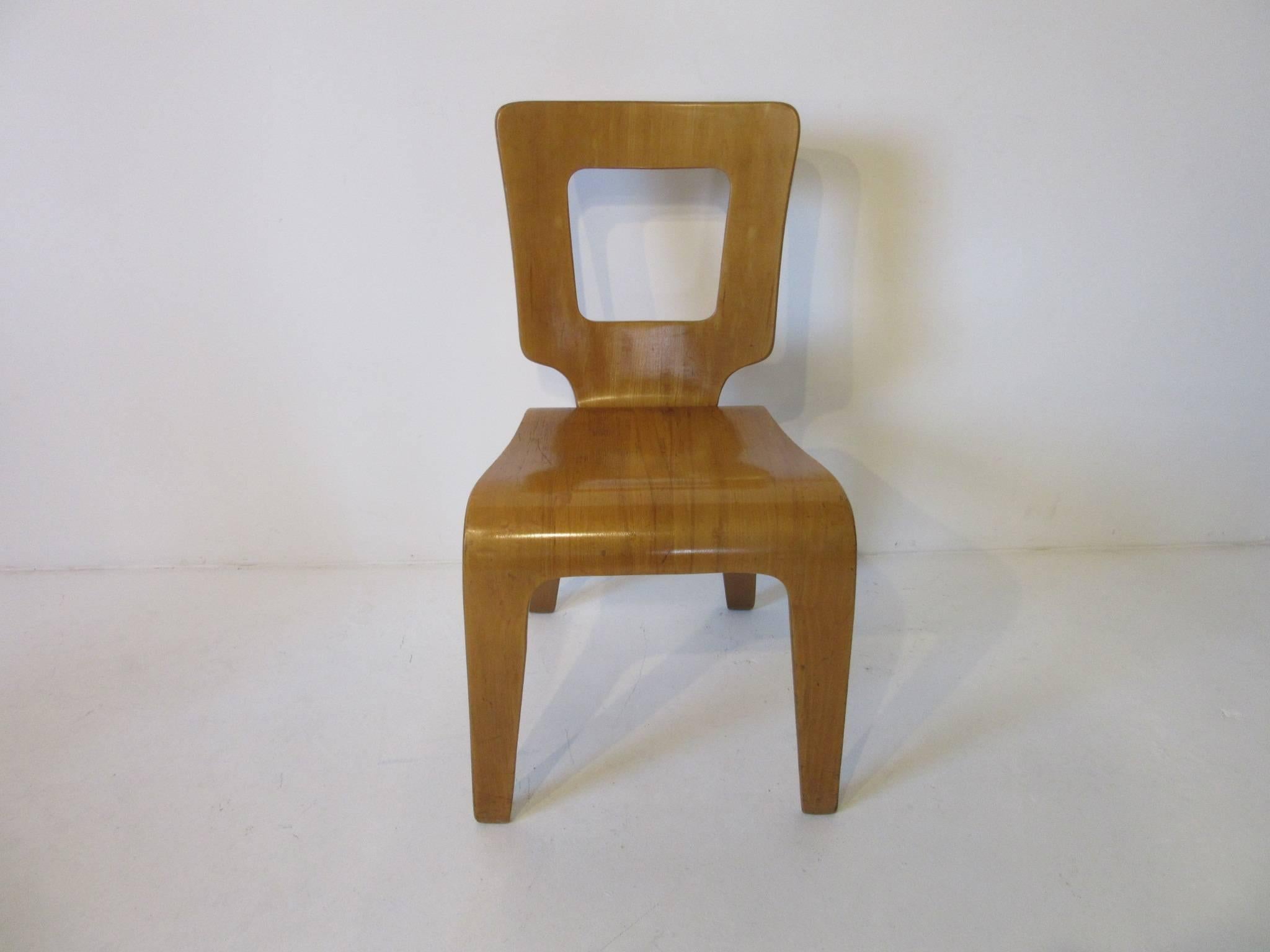 A pair of molded plywood side chairs by Herbert Von Jordan who during the period of the 1940s used building methods founded in World War II, using molded plywood in the manner of Eames and other top designers of the period. Retains the ink stamp and