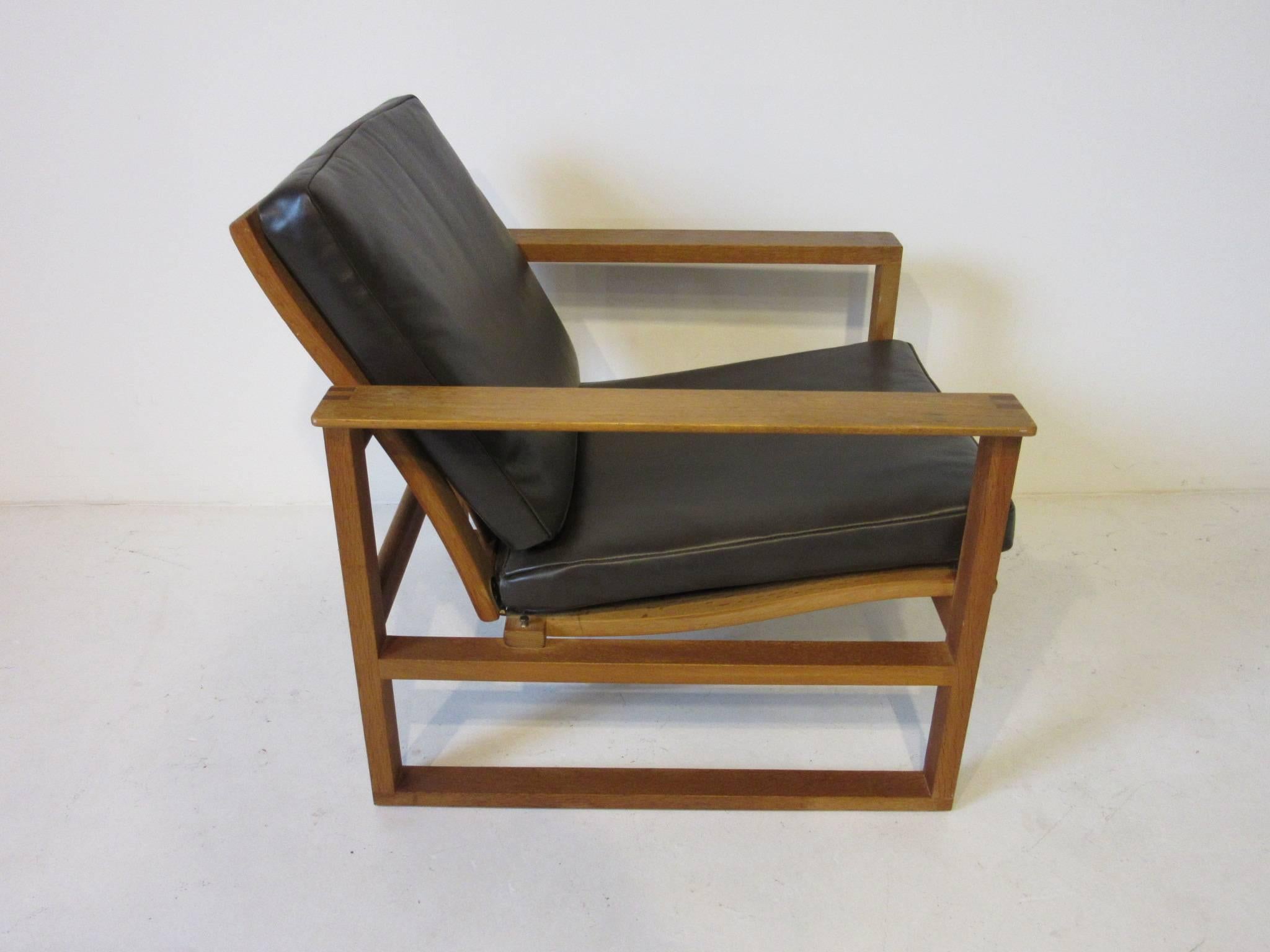 A Mogensen wood framed sled lounge chair with rich and smooth dark brown toned leather cushions. Retains the manufactures tag- model # 2256 serial # 675/ Aktieselskabet Denmark - Fredericia Stolefabrik.