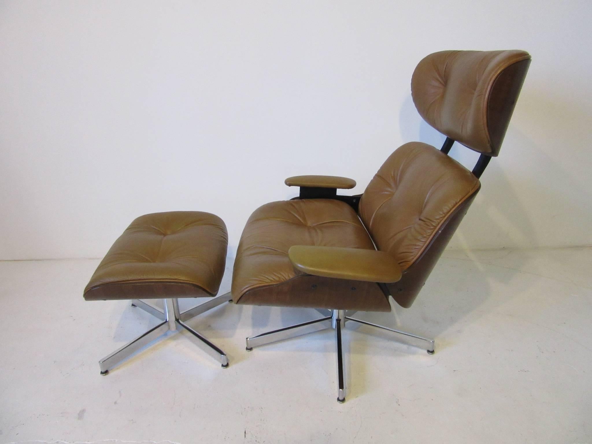 A cognac colored leather lounge chair with matching ottoman and bent walnut body with chromed metal bases. The plycraft model has an adjustable spring for rocking and comfort unlike the Eames chair which has a set angle and is uncomfortable to some.