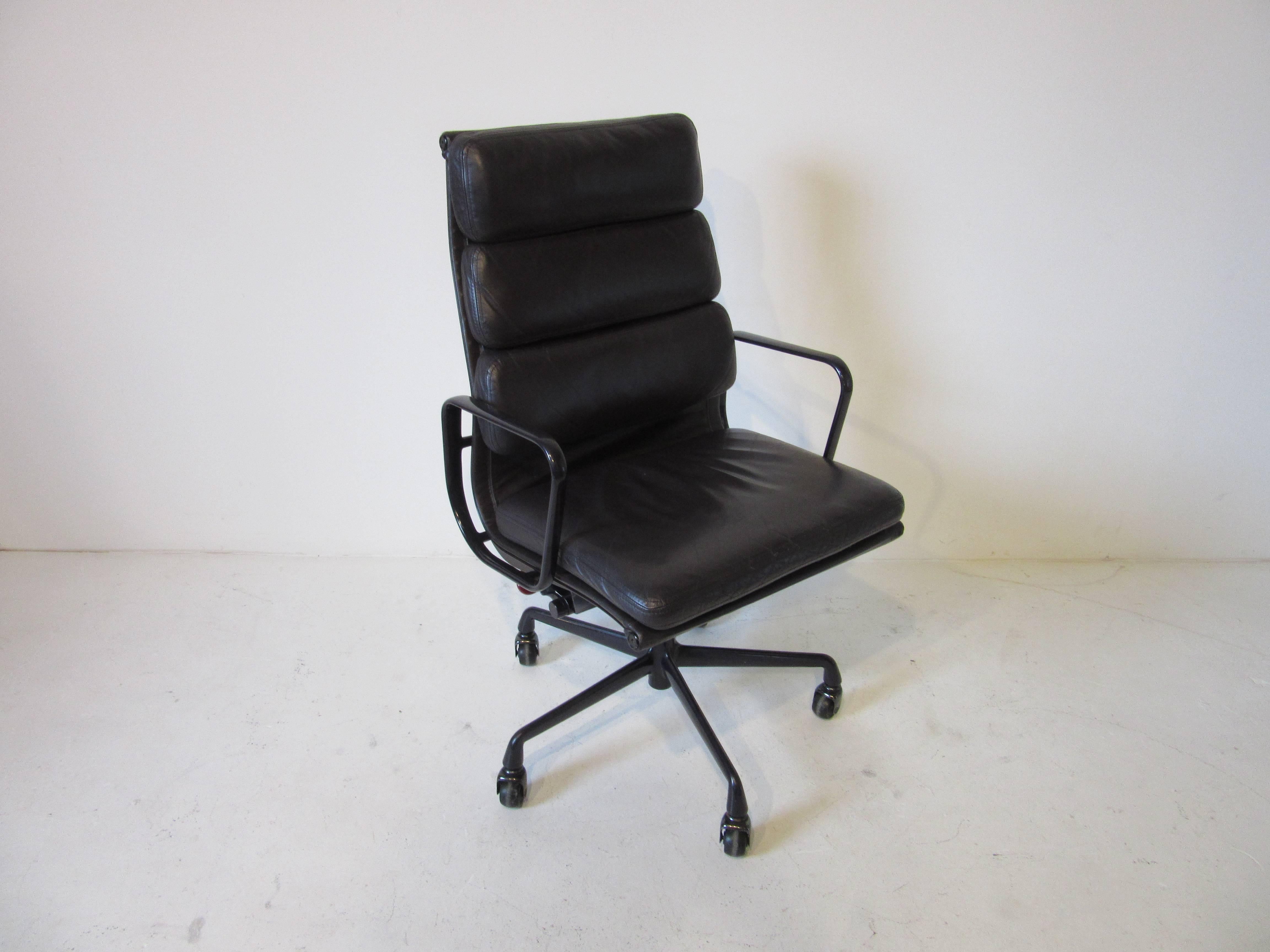 A rich and buttery soft leather aluminium group rolling executive armchair special ordered in a dark eggplant with matching arms and base . Manufactured by the Herman Miller Furniture Company. The chair is adjustable with seat height measures: 26