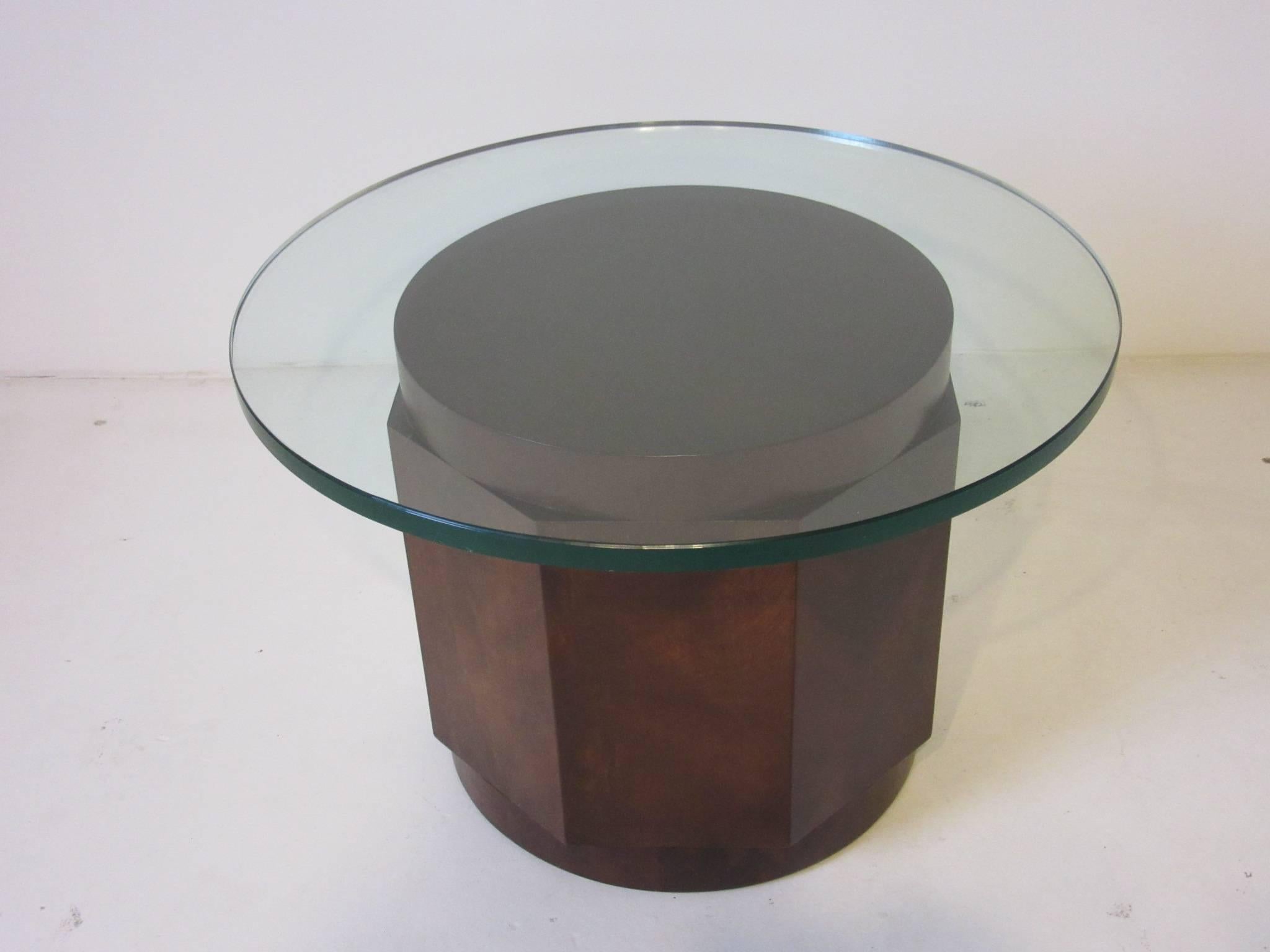 A dark walnut octagon shaped side table with round plate glass top designed by Edward Wormley for the Dunbar furniture company. A rich and well crafted piece of furniture that will last a lifetime.