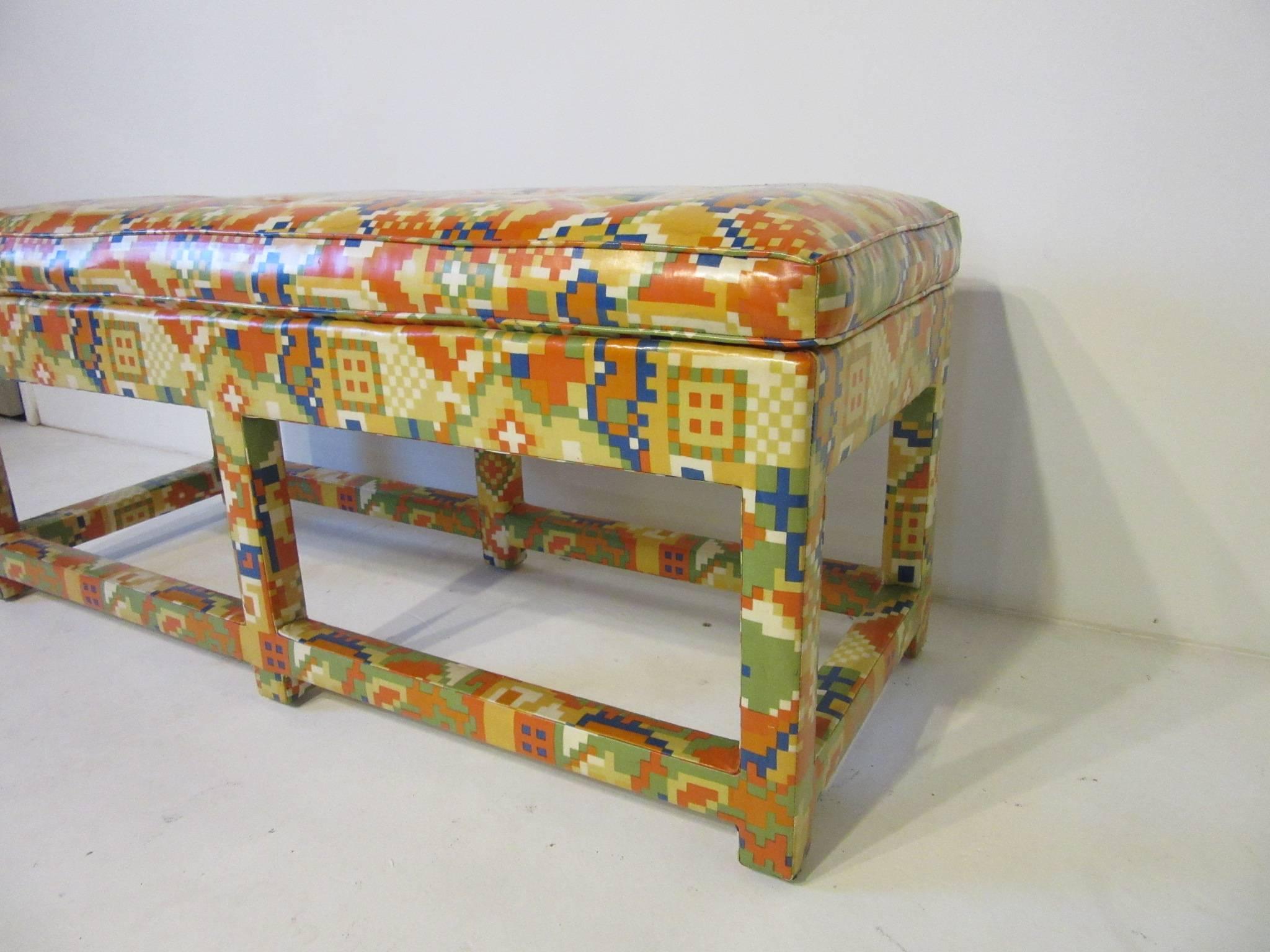 An upholstered bench with colorful, 1980s patterns in oil cloth with lower stretchers, from the period, well-crafted and perfect for that dash of color. Designed in the style of Karl Springer and Steve Chase.