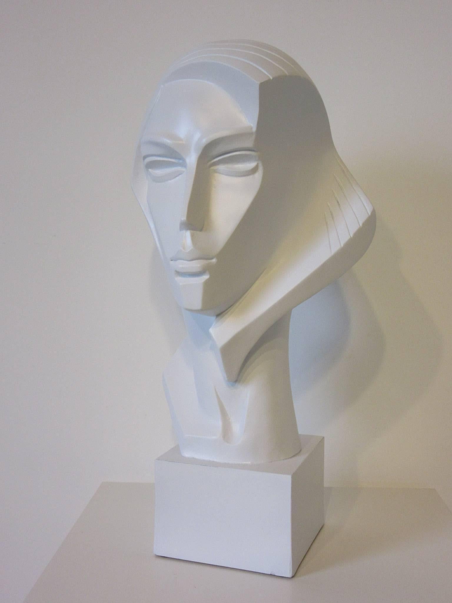 A large plaster female bust in the 1980s vibe reminiscent of Studio 54 in satin white on a wooden base, signed to the back neck area Austin Products 1987, Fischer.