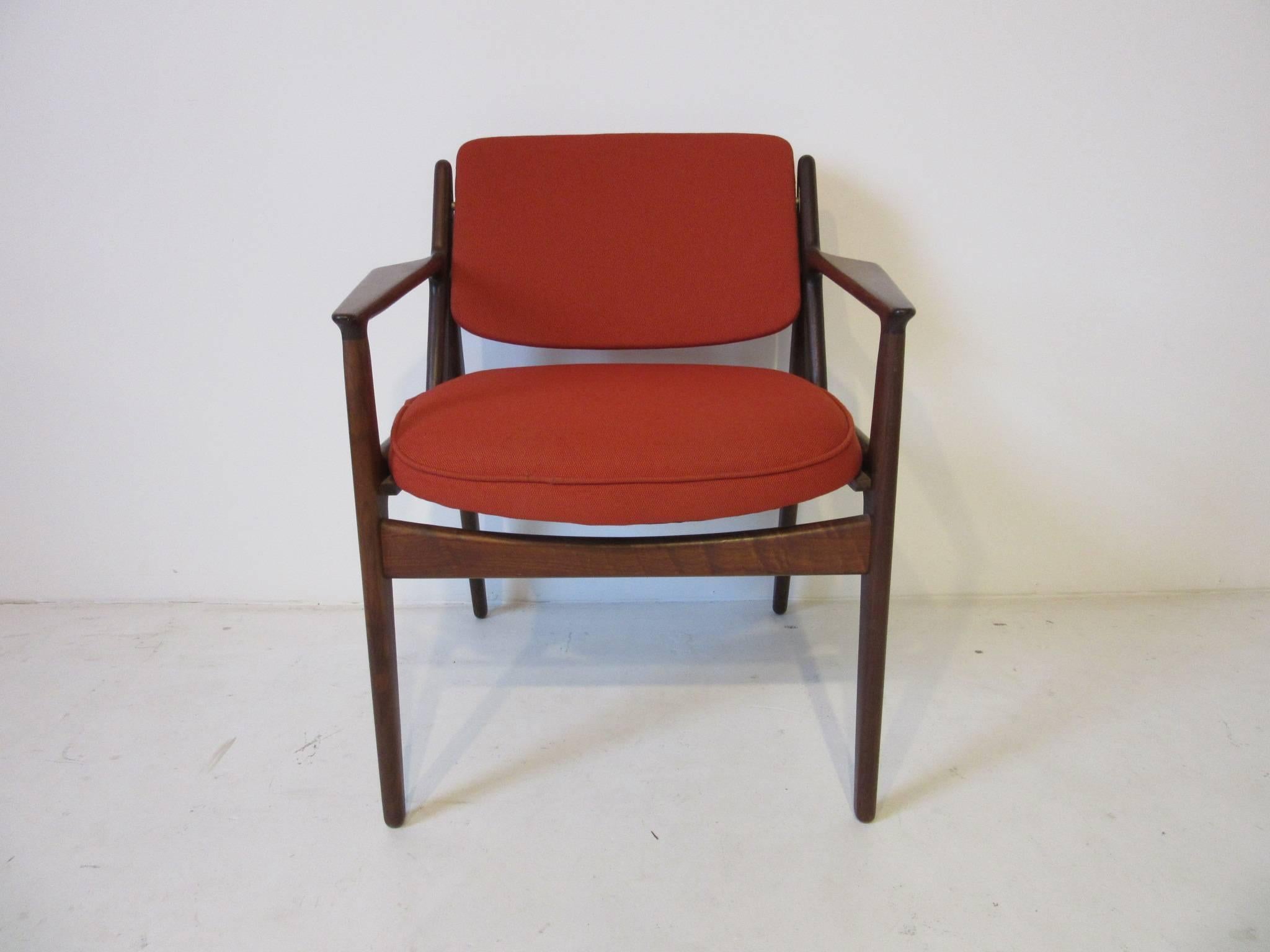 An upholstered Arne Vodder tilting back arm chair having a nicely padded bottom and back cushion with sculptural dark wood frame constructed in Denmark. Very sturdy and with the tilting back it's super comfortable ,measurement of the seat height is