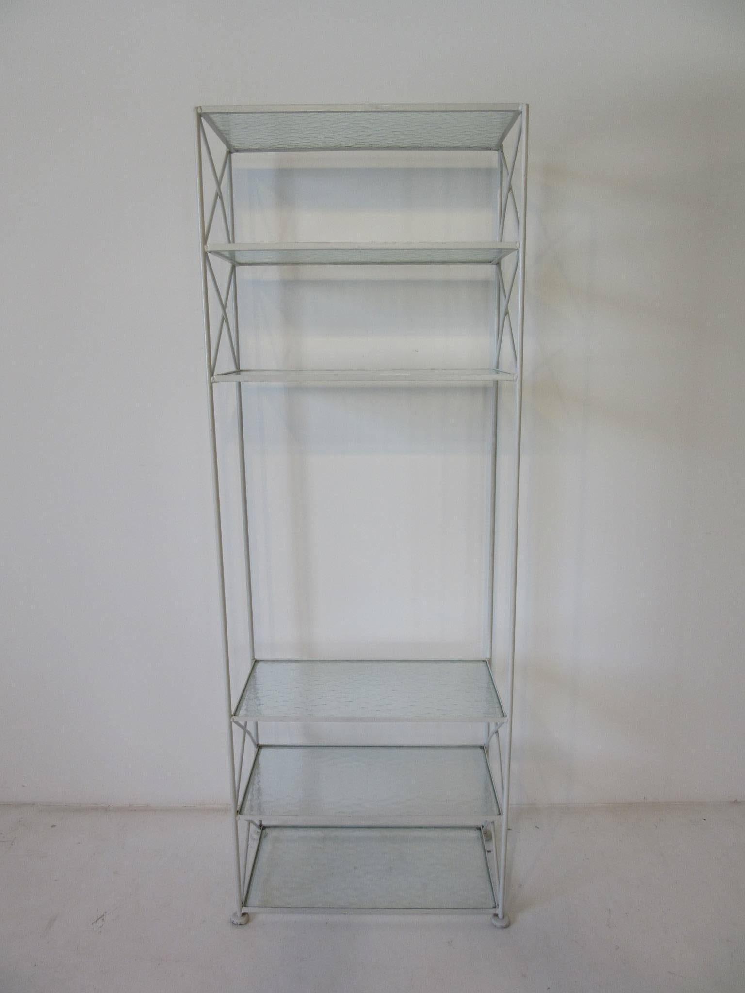 A hard to find satin white iron etagere or bookcase with pebbled glass shelves and X cross bracing a perfect companion to any Woodard furniture and great for finishing off your three seasons room or interior . Can be used outdoors depending on the