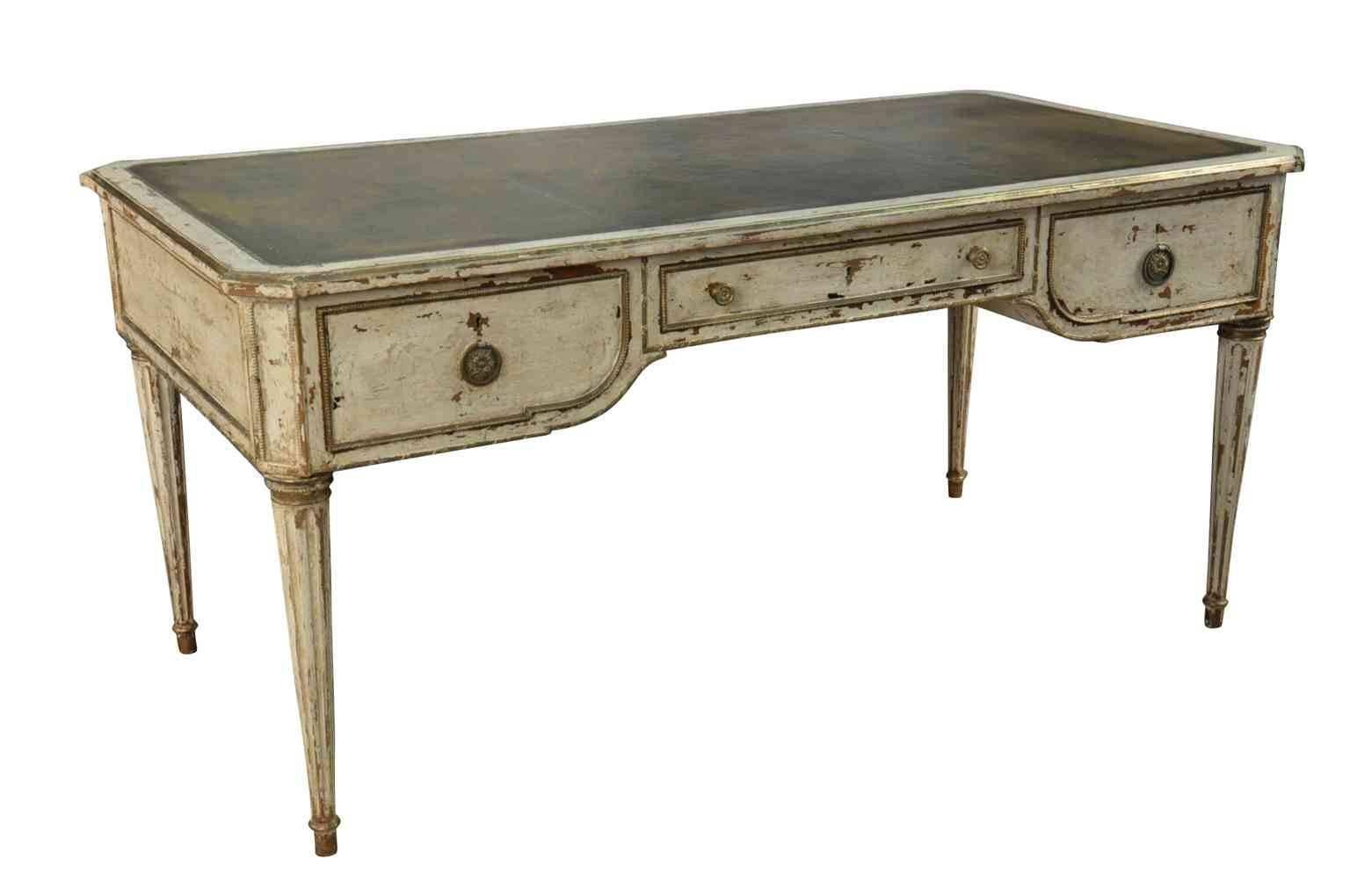 A very lovely 19th century French Louis XVI style desk or writing table in painted wood with leather inset top. Wonderful painted finish and patina. The finish is in a 