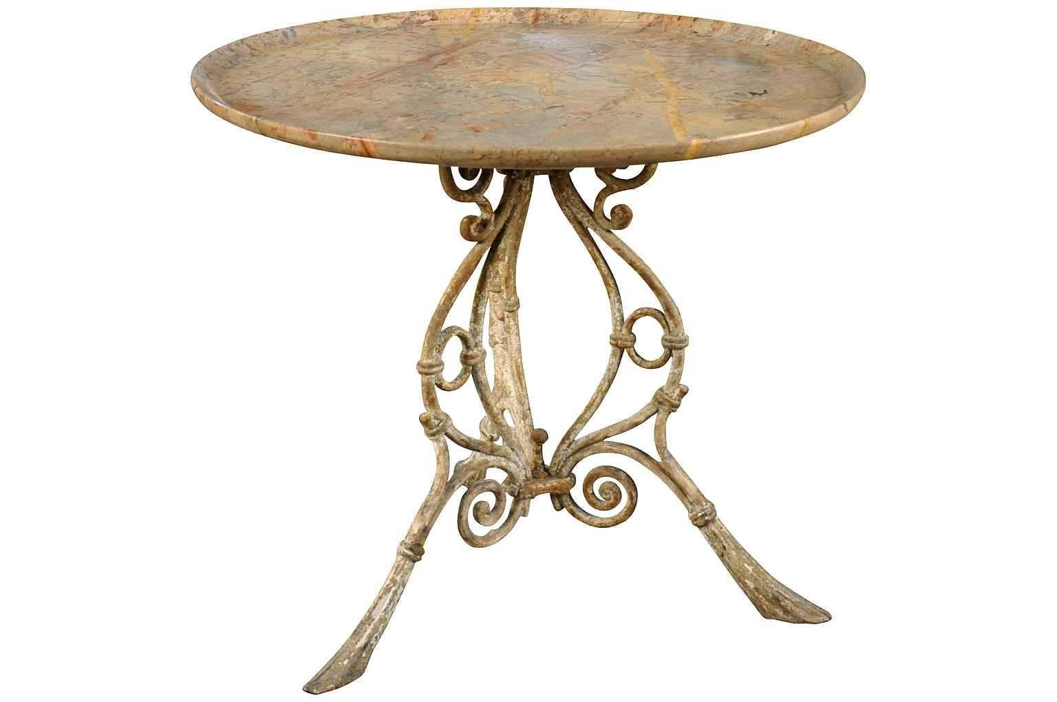 An outstanding 19th century Gueridon from the Provenance region of France. Terrific painted iron base with a unique sculpted marble top. A perfect table for any interior of garden.