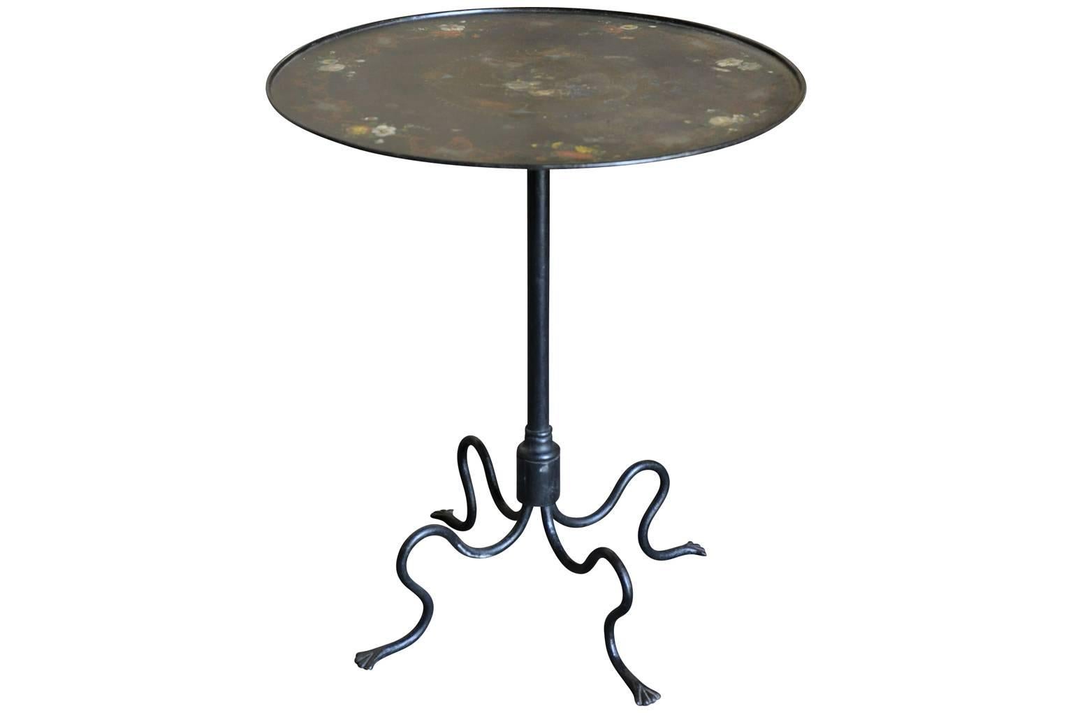 An outstanding and exceptional French Napoleon III tilt-top gueridon. Masterly crafted from painted iron with stunning painted details. The base is so unique and wonderful. A perfect accent piece to any living area.