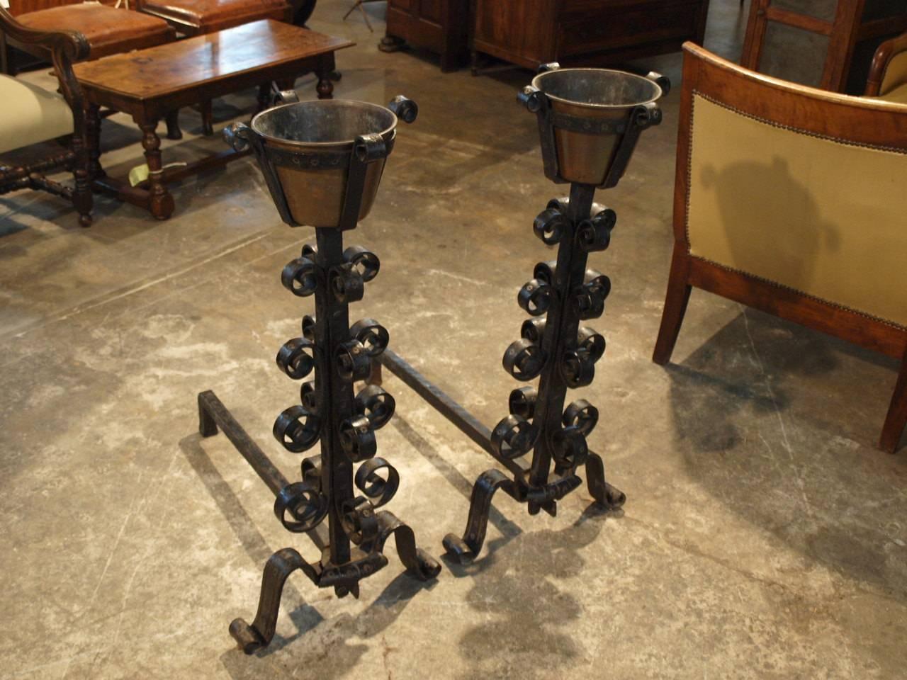 An outstanding pair of French late 18th century hand-forged andirons with their original copper vessels. Expertly forged and embossed with decorative ornamentation. Forged by a Compagnon member - a French organization of craftsmen and artisans