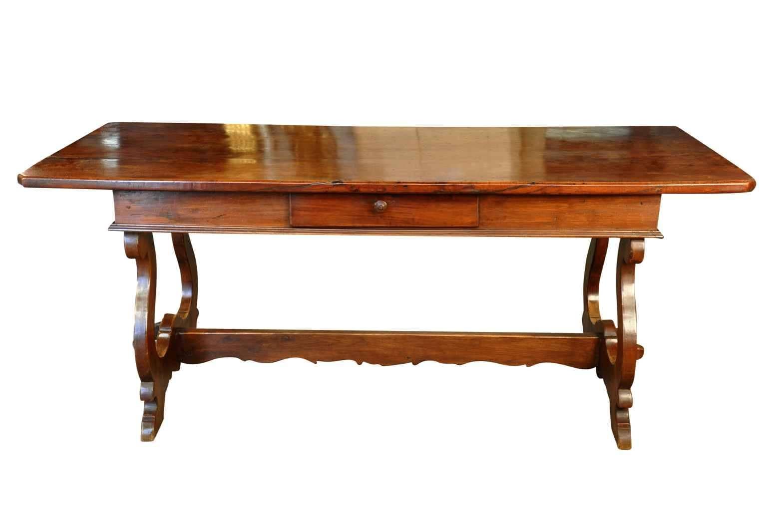 A very elegant mid-19th century desk - writing table from Italy.  Beautifully constructed with classical lyre legs and trestle.  One drawer.  The patina is rich and luminous.  Not only does this piece serve wonderfully as a desk, but as a sofa table