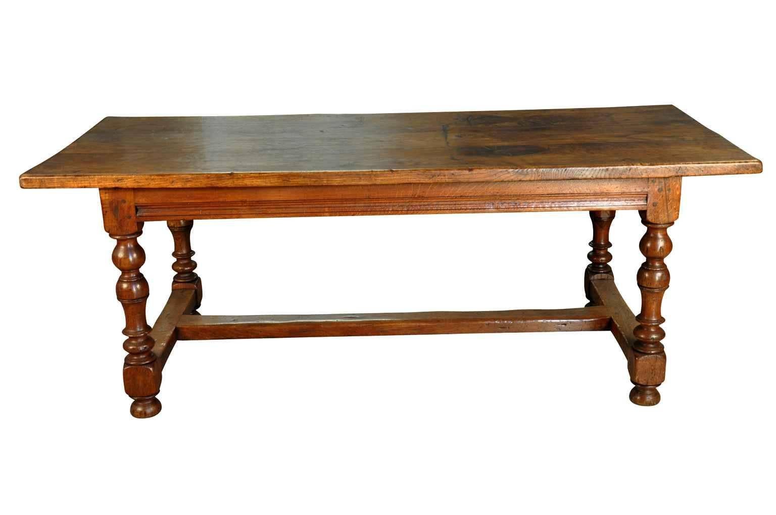 A very handsome 19th century Farm Table in chestnut from France.  Beautifully constructed with shapely turned legs and a trestle base.  The patina and grain on this piece are rich and luminous.  Wonderful not only as a writing table, but serves