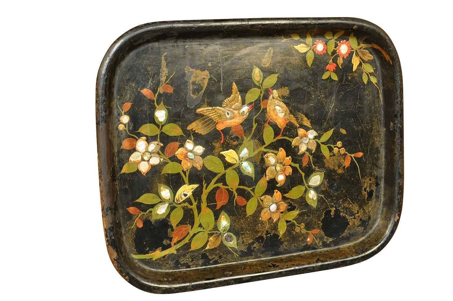 A stunning French early 19th century polychromed and mother of pearl tole tray.  The patina is wonderful - beautifully textured paintings and mother of pearl in very handsome colors.  A terrific accessory piece whether placed on an ottoman, table