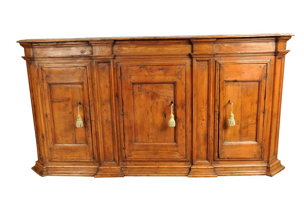A very stately 18th century credenza from Northern Italy. This very handsome sideboard is beautifully constructed from a richly stained pinewood - luminous patina throughout.