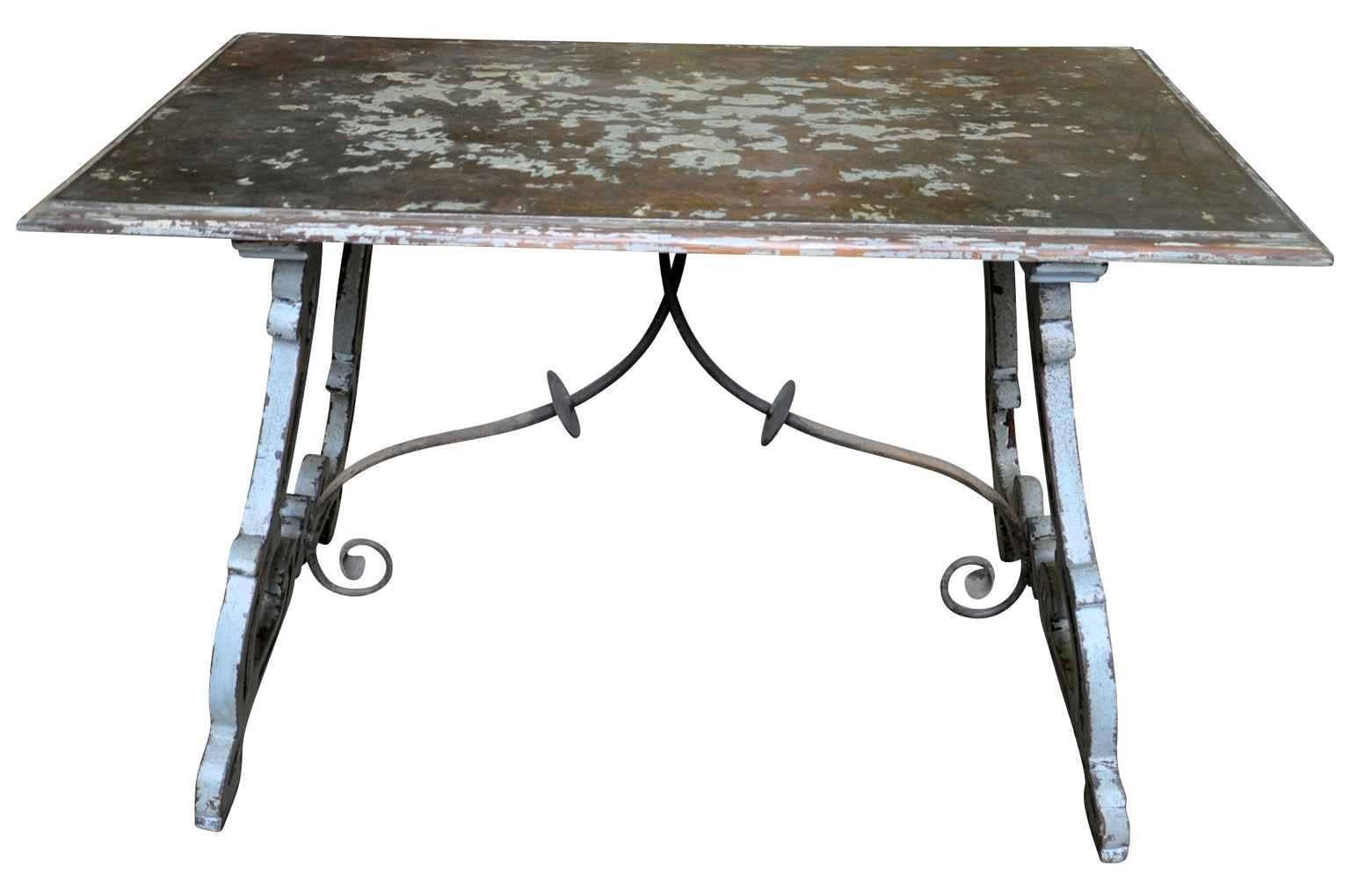 A very charming 19th century small farm table in painted wood with iron stretchers. Beautifully constructed with classical lyre legs. The top surface is wood with a wonderfully patina's metal surface, great looking! Ideal as a smaller dining table