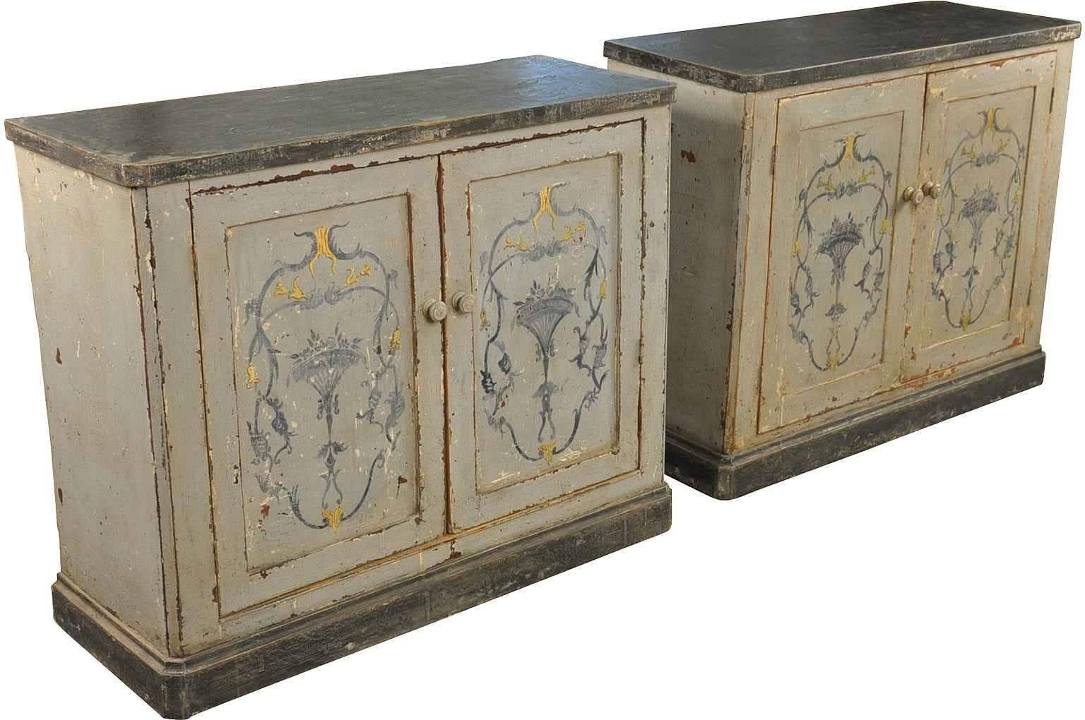 A charming pair of mid-19th century painted buffets from Portugal. The wonderful and textured finish is in hues of a Classic grey, almost black top surfaces and lovely decorative painting. These pieces are wonderful in any living situation and also