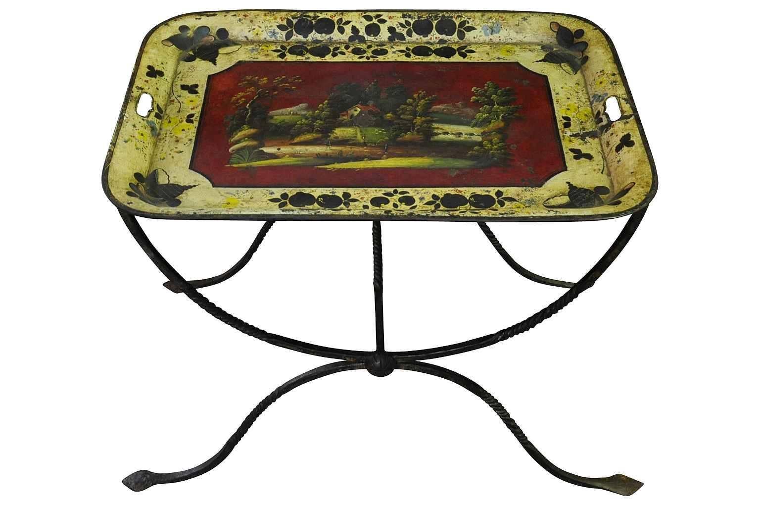 A delightful French side table composed of a very handsome wrought iron base with the removable polychromed tole tray top. I terrific accent piece giving a pop of color.