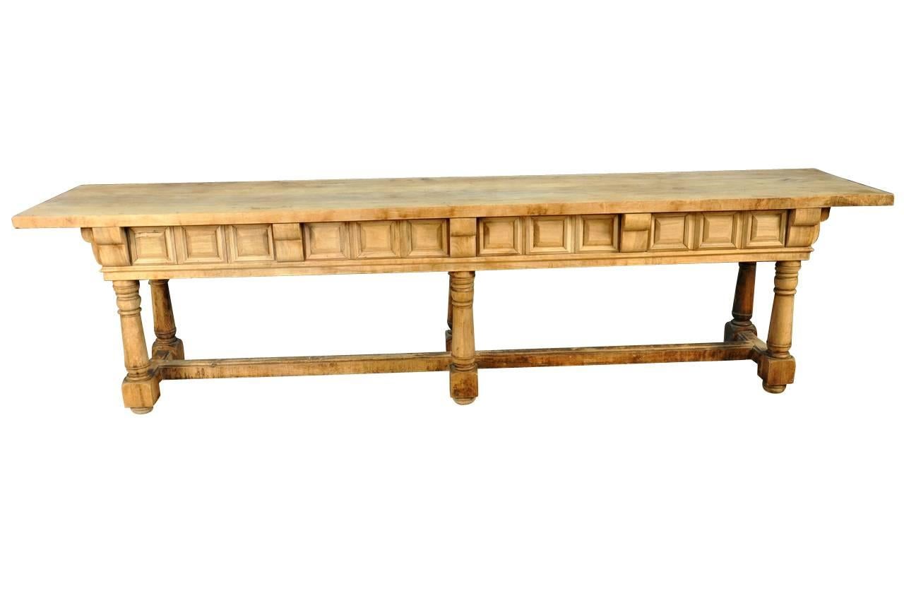 A very handsome early 19th century long console table in washed or bleached walnut from the Catalan region of Spain. This table has four secret drawers. This console serves wonderfully as a long sofa table or sideboard piece.