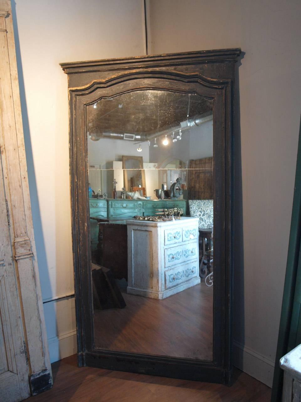 A very handsome large scale trumeau mirror created from an 18th century Italian door frame. Wonderful molding with a beautiful painted finish. Terrific whether mounted to the wall or propped against the wall.