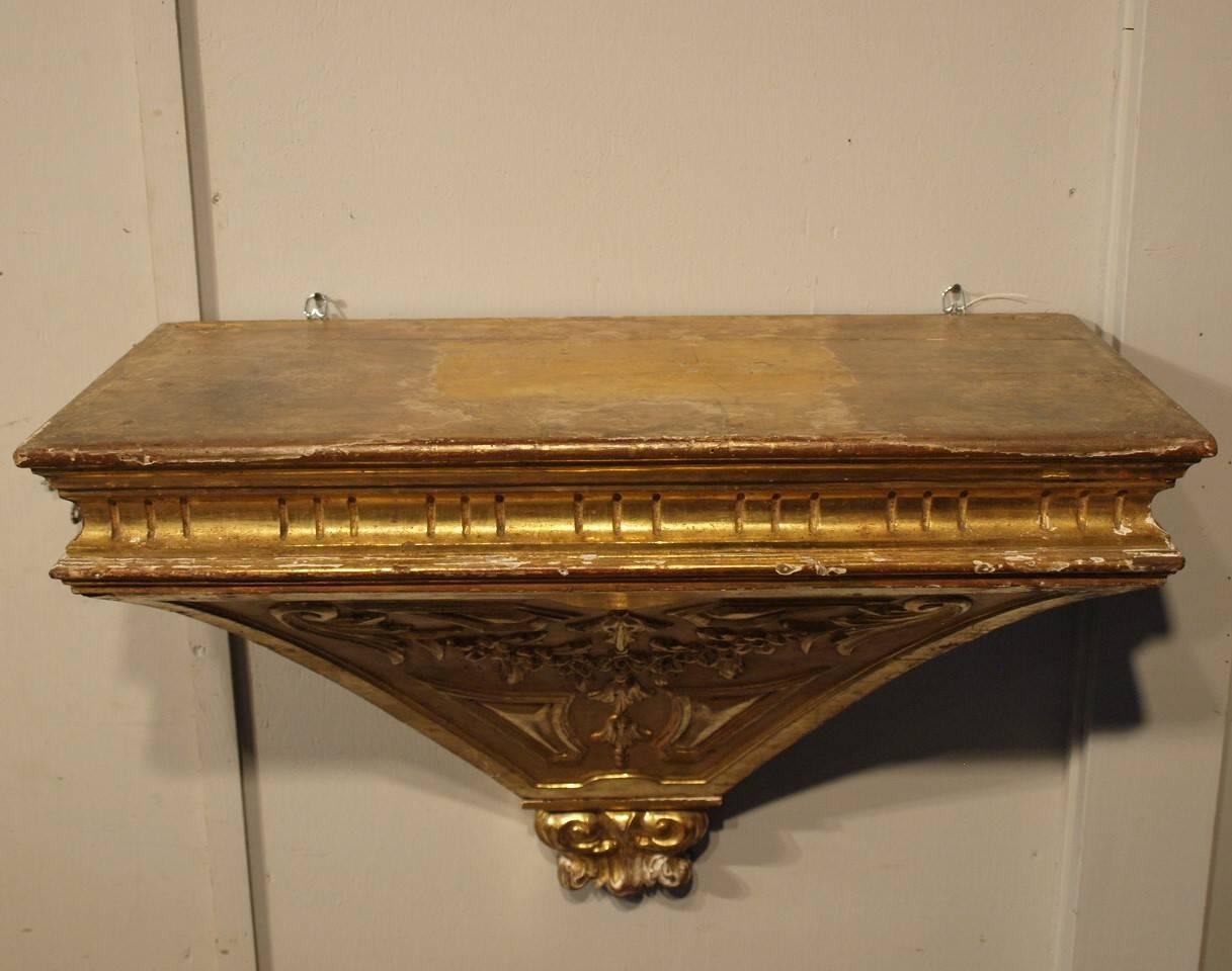 18th century wall suspended console from Northern Italy. Beautifully constructed in giltwood and ornamented with a Louis XVI influence. Please note the last image, by inverting this piece, it can become a stunning bed crown.