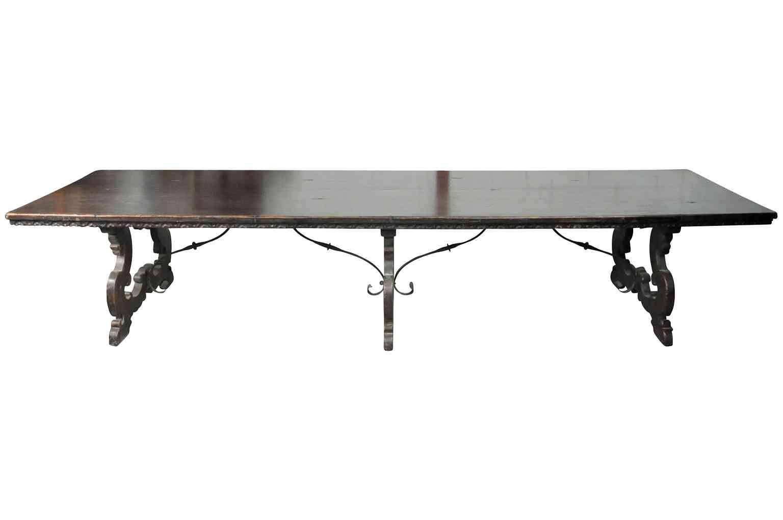 A monumental and unique 17th century style farm table, trestle table from Northern Italy. Masterly crafted from very sound and thick planks of antique walnut. The two board top has a wonderfully carved edge finish. The three sets of legs are