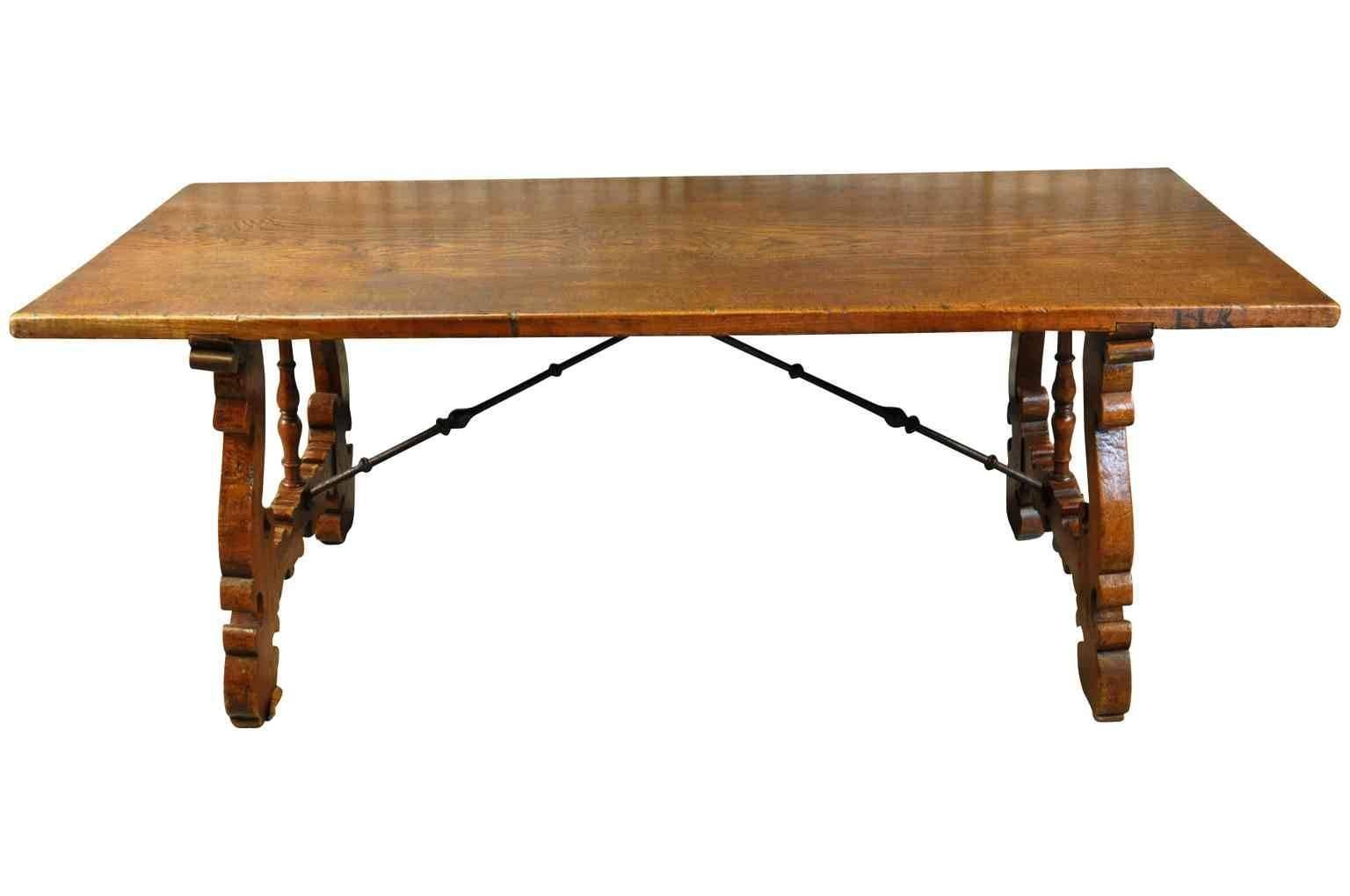 A very handsome 19th century Spanish farm table - trestle table. Beautifully constructed from chestnut and hand-forged iron stretchers. The top surface is a solid board! The patina and tone is rich and luminous.