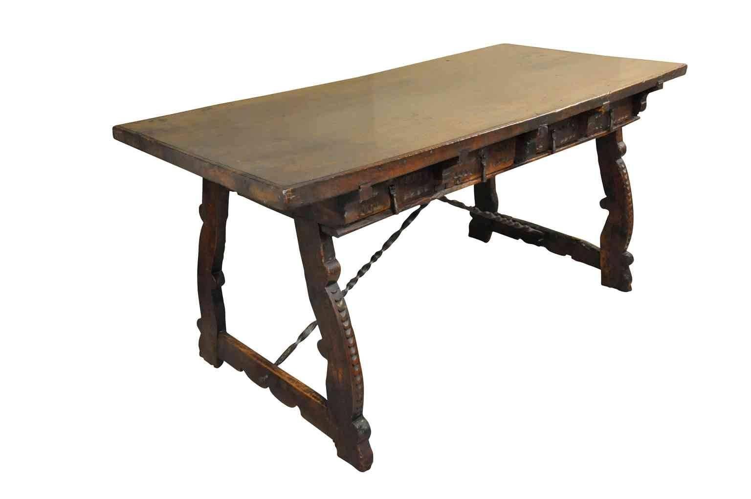 An outstanding 17th century table or desk from the Catalan region of Spain. Masterfully constructed in walnut with hand-forged iron stretchers. The patina and graining are exceptional rich and luminous. Stunning.