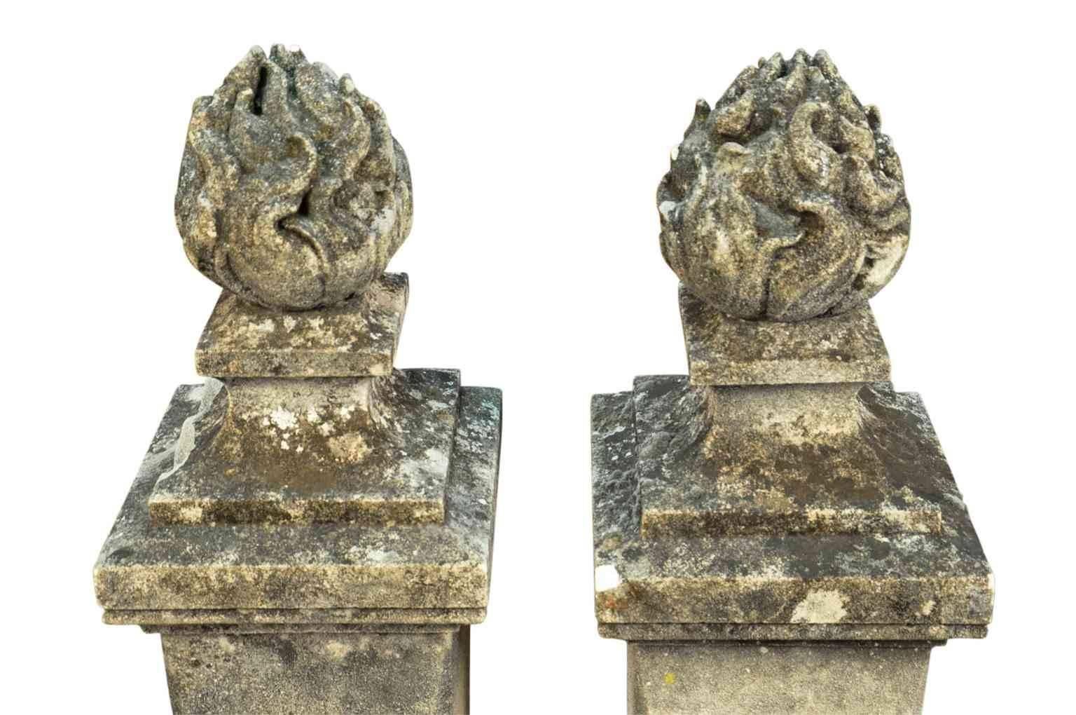 An outstanding pair of 19th century flambeaux finials, flame finials from France. Masterly carved with a fantastic patina. Not only fabulous as a garden decoration, but as an interior accent as well.