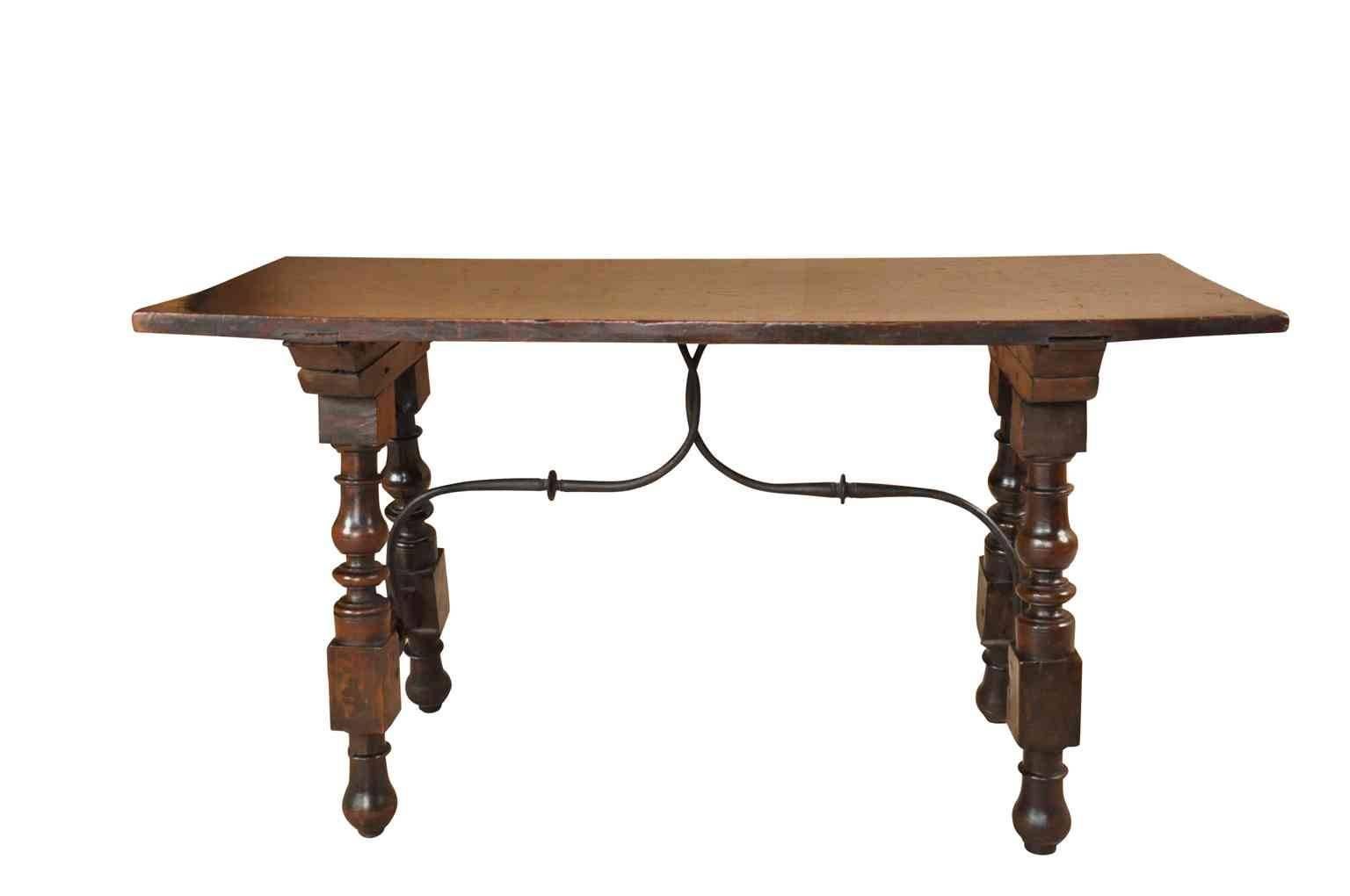 A very beautiful 18th century diminutive side table or console from the Catalan region of Spain. Wonderfully constructed from walnut with a solid board top, nicely turned legs and hand-forged iron stretchers.