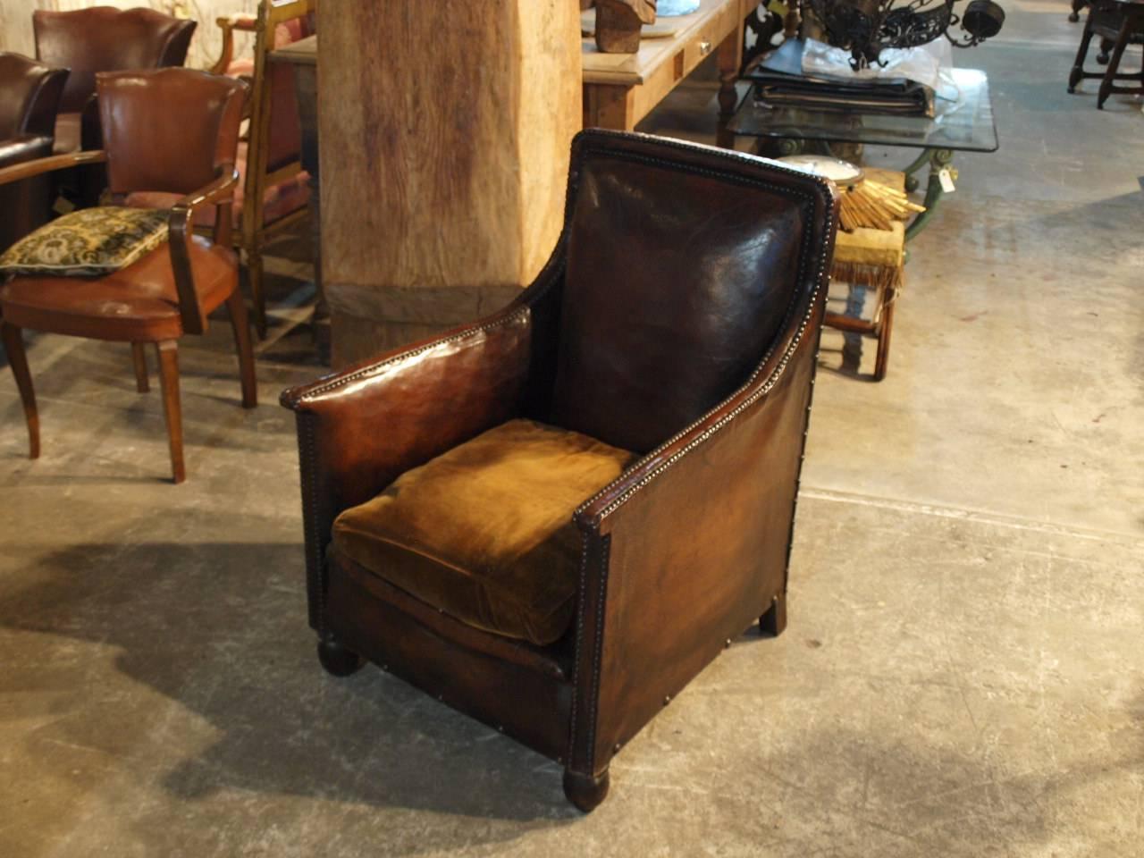 A very handsome French Art Deco club chair in leather with striking nail head detailing. Very comfortable with a rich patina.