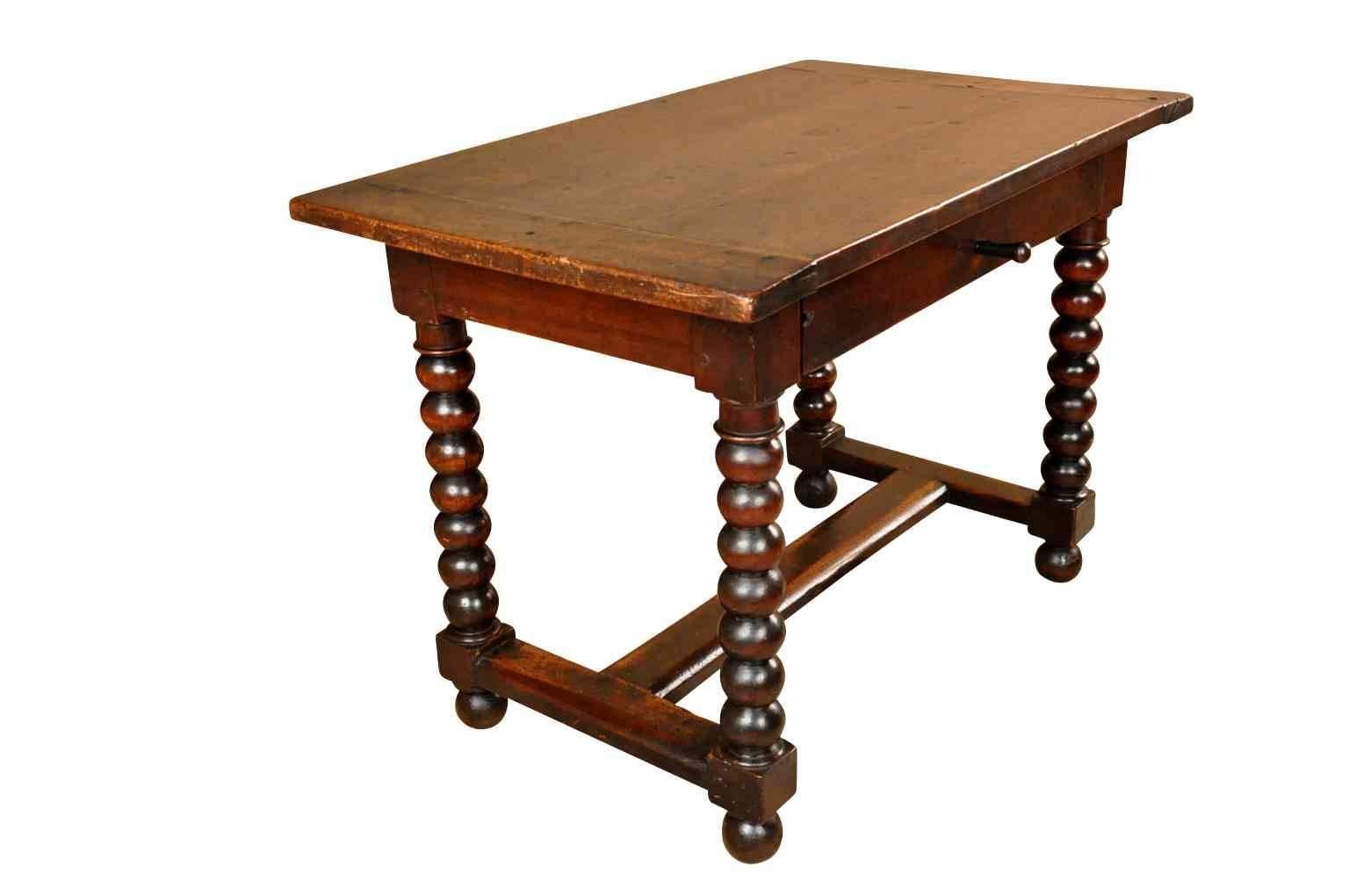 A very handsome French Louis XIII style side table or writing table. Beautifully constructed from walnut with boldly turned legs and a single drawer. The patina is very rich and luminous.