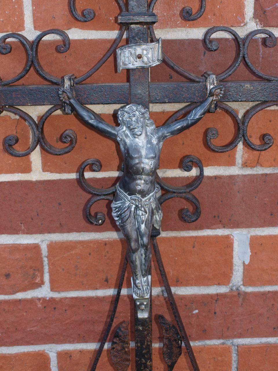 A wonderful late 19th century Garden Crucifix from the North of France. Very well constructed in hand wrought iron. Beautiful to wall mount or to embed into a pedestal.