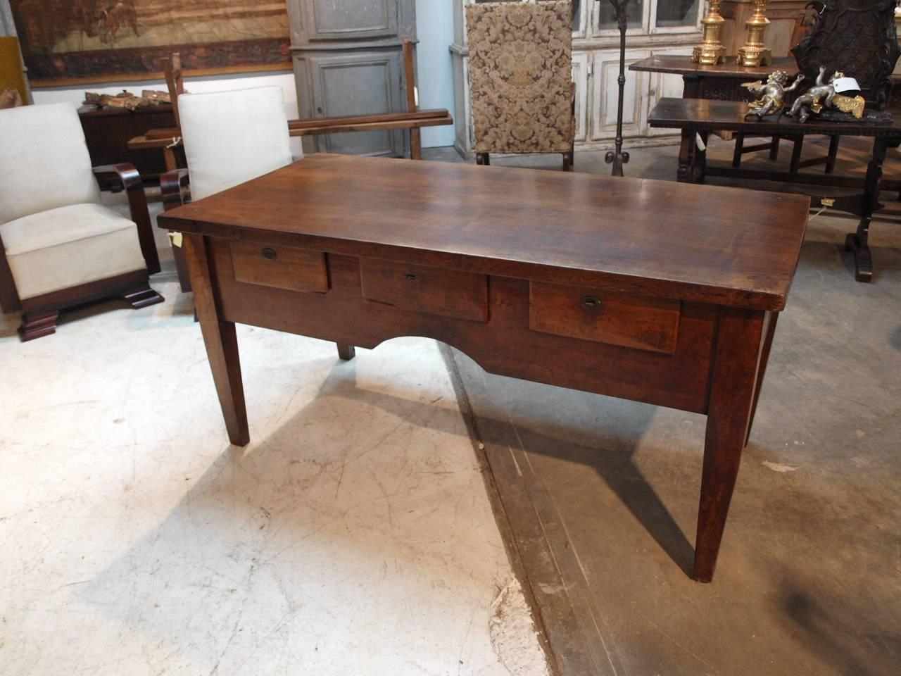 A very handsome early 19th century work table from the Catalan region of Spain. Beautifully constructed from very thick walnut. The top is solid board, the patina sumptuous and very rich. Three drawers to one side and one drawer to the other. Nice