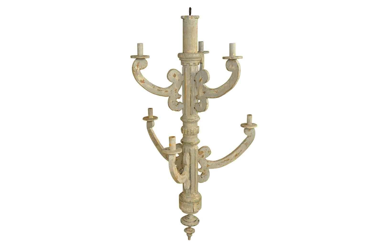 A very attractive pair of Spanish chandeliers in painted wood.  These terrific pieces are constructed from 18th century elements and have a wonderful painted finish in soft tones of grey with a hint of blue.  The chandeliers may be sold