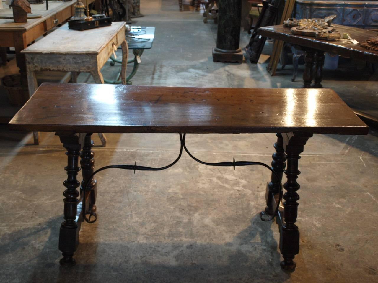 A very handsome 18th century console from the Catalan region in Spain. Beautifully constructed in walnut with a solid board top, turned splayed legs and hand forged iron stretchers. Serves wonderfully as a sofa table or serving table as well.