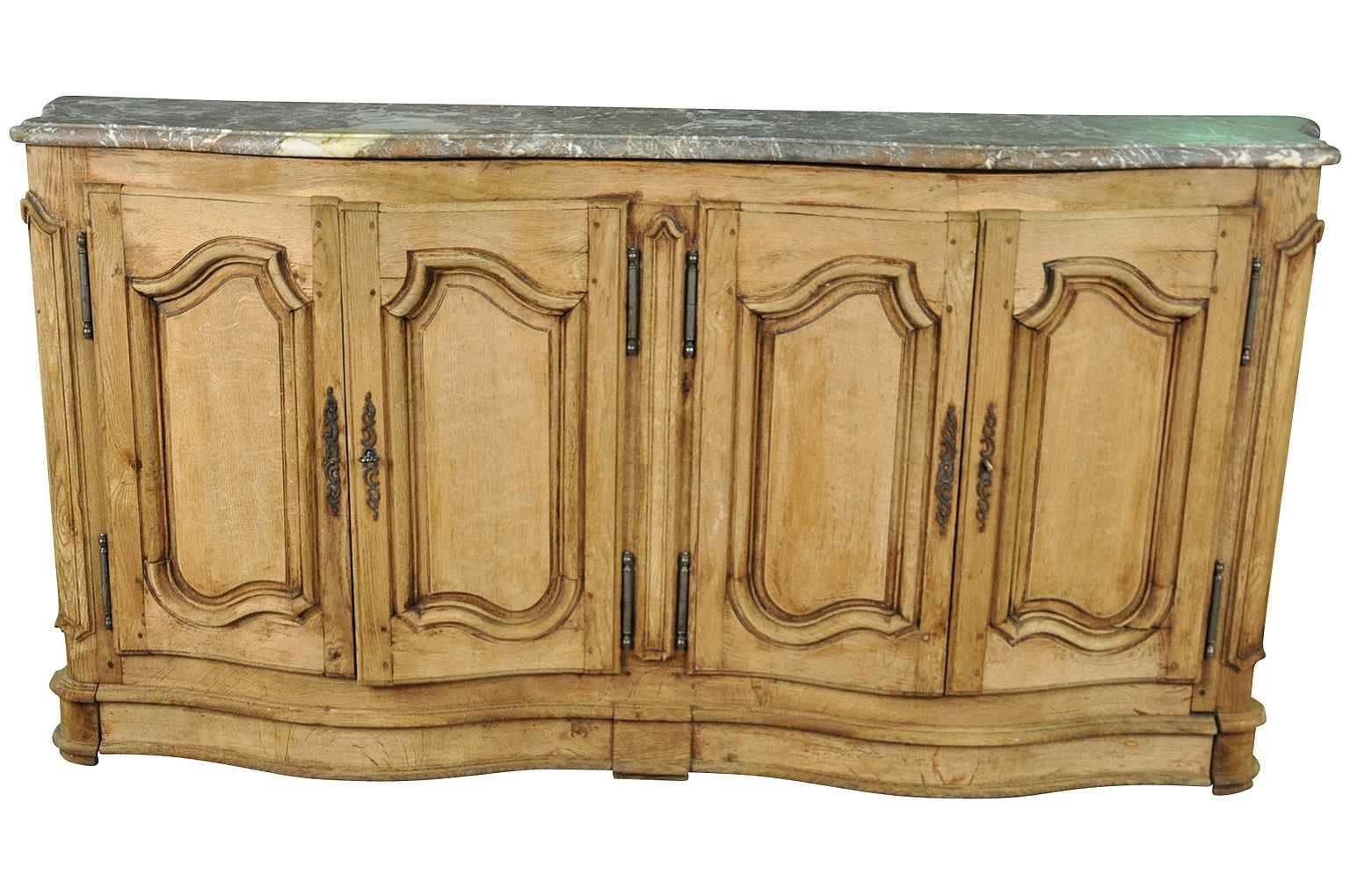 A stunning 19th century French hunt buffet with its original marble top. Beautifully constructed from washed or bleached oak curvilinear fascia with two sets of double doors.