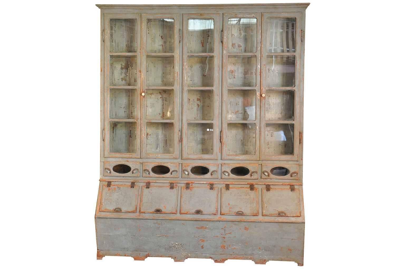 A sensational 19th century Grenotier, grain storage cabinet from Portugal. This very handsome deux corps bookcase origins from a Mom and Pop grocery store. It serves as a tremendous kitchen cabinet or a perfect bookcase for any living area.