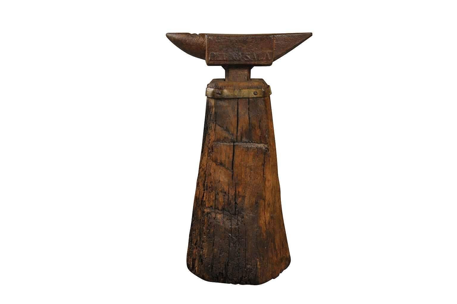 A terrific 19th century Enclume, anvil from the Catalan region of Spain. This anvil retains its original wooden base with iron fittings. A super piece of artwork or sculpture.