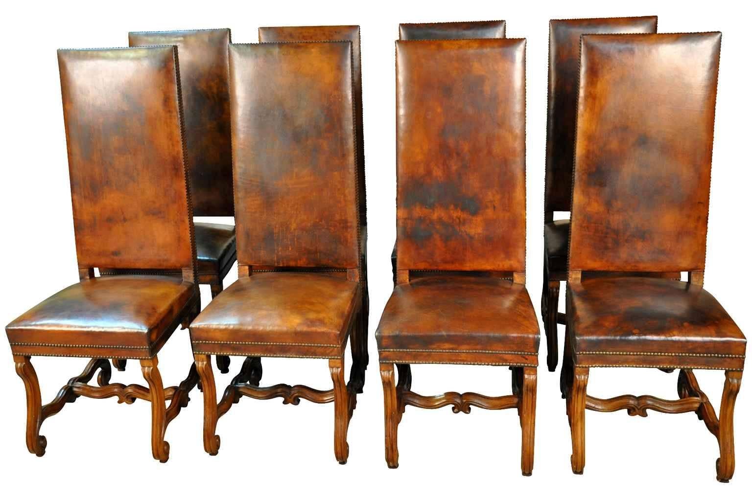 A very handsome set of eight 19th century Louis XIV style dining chairs from the Catalan region of Spain. Wonderfully constructed from walnut and leather - handsome nailhead detailing.