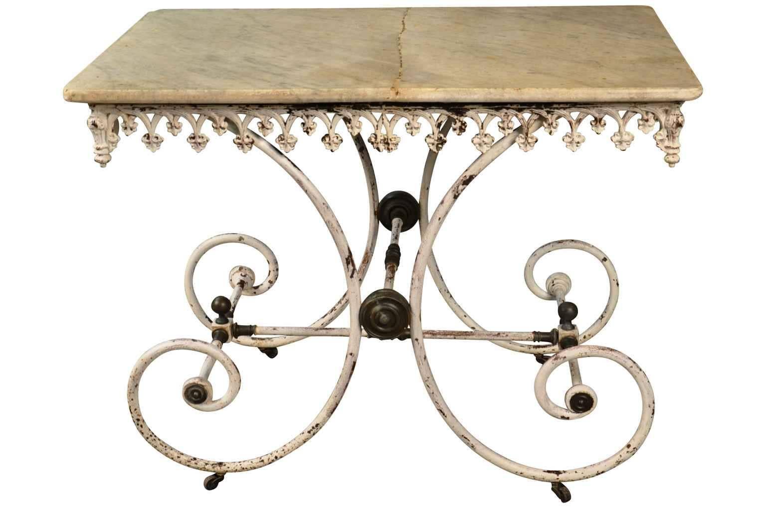 A wonderful 19th century French butcher table from the South of France. Handsomely constructed with a cast iron base and marble top. The table retains its original casters.
