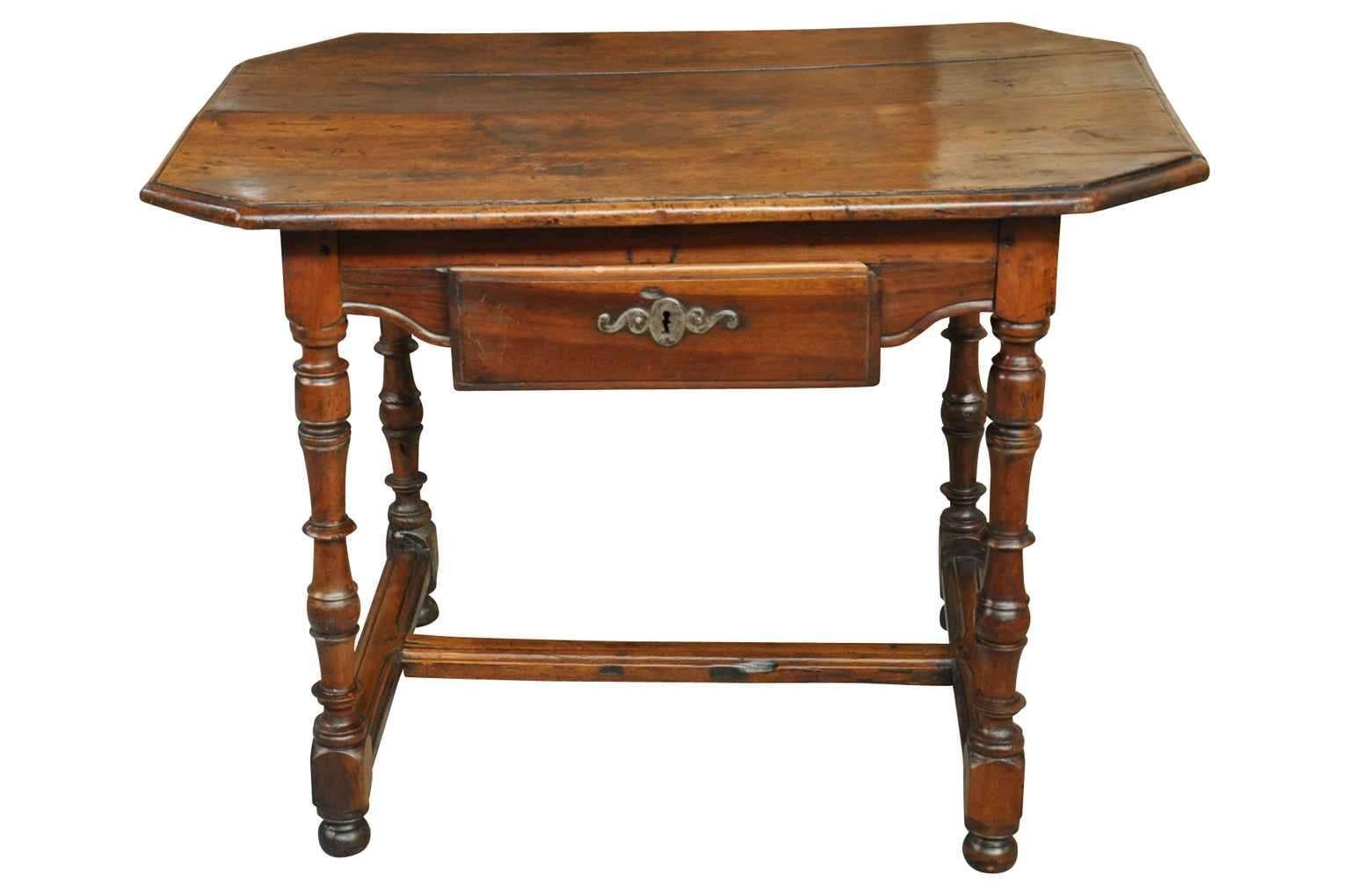 A charming later 19th century Louis XIII style writing table or side table from France. Beautifully constructed from walnut with a handsomely shaped top, single drawer and turned legs. Wonderful patina.