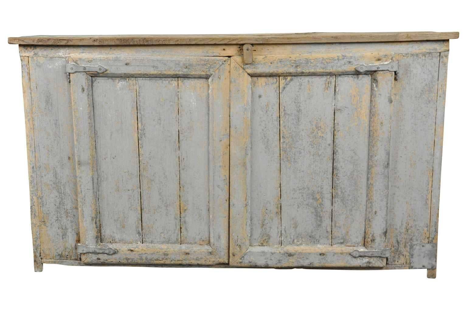 An 18th century French Primitive buffet in painted wood from the South of France. Wonderful painted finish in soft hues of powdery blue. Nice narrow depth.