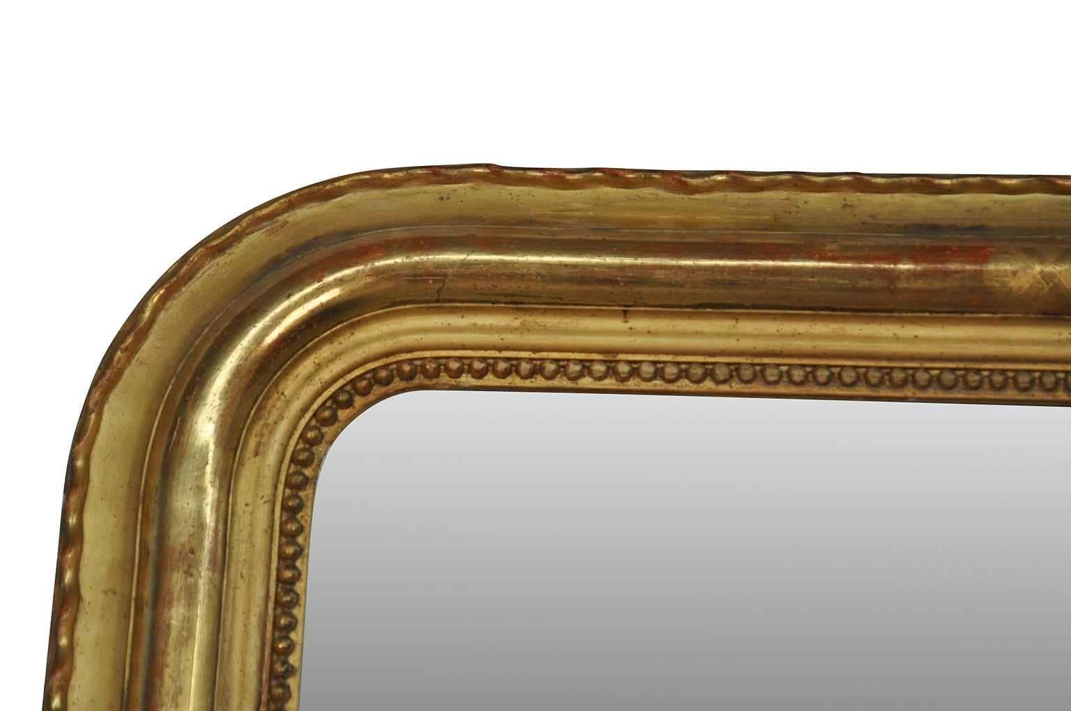 An absolutely outstanding and monumental Napoloeon III period mirror in giltwood. The shear size of this mirror is sensational just shy of 9 feet. Beautifully adorned with an "x" pattern in water gilding. Original mercury glass mirror. The