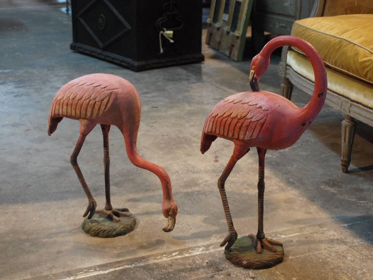 A terrific pair of vintage pink Flamingo statues from the South of France in painted cast iron. Wonderful color. The taller flamingo measures 24