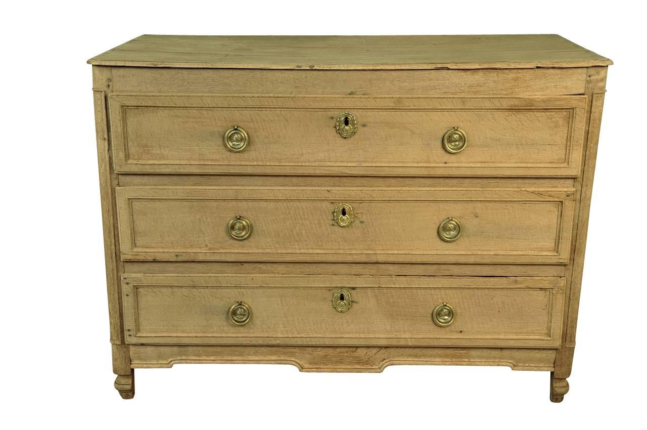 A very handsome late 18th century, early 19th century commode in washed or bleached oak from Northern France.