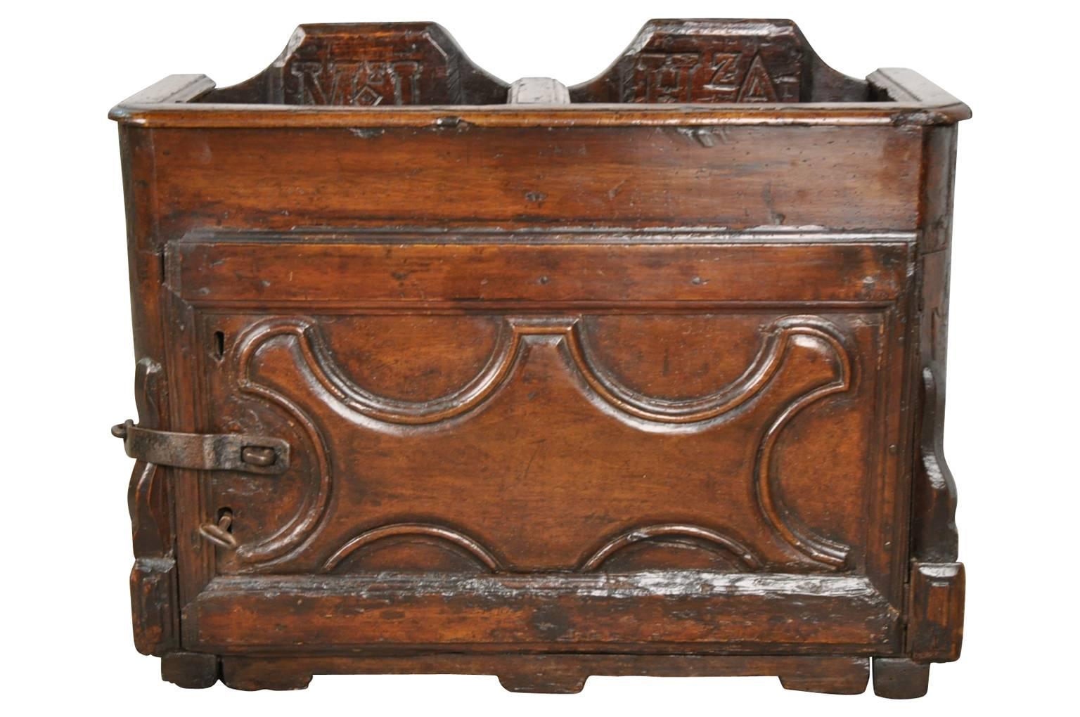A rare and unique church collection box from Northern Italy. Beautifully constructed from thick planks of walnut with intriguing carving detail. A wonderful addition to any church or chapel. As well, this piece can be the perfect piggy bank!