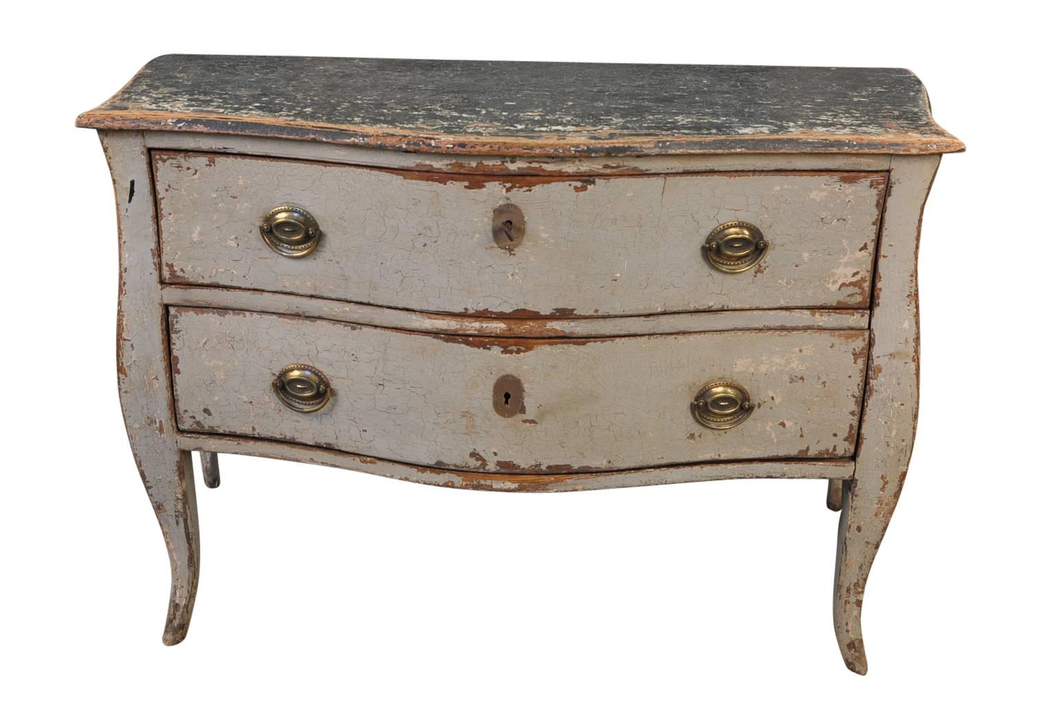 A very lovely French mid-19th century painted commode. Beautifully constructed with a graceful serpentine movement, two drawers on soft cabriole legs. A wonderful piece for any foyer, living area or bedroom. It would also convert beautifully into a