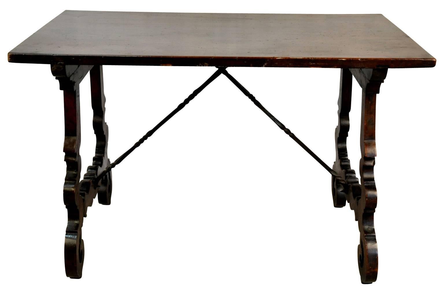 A stunning 18th century Spanish table, side table from the Catalan region of Spain. Beautifully constructed from walnut with a wonderful solid board top, classical lyre shaped legs and hand-forged iron stretchers. A magnificent piece whether used as