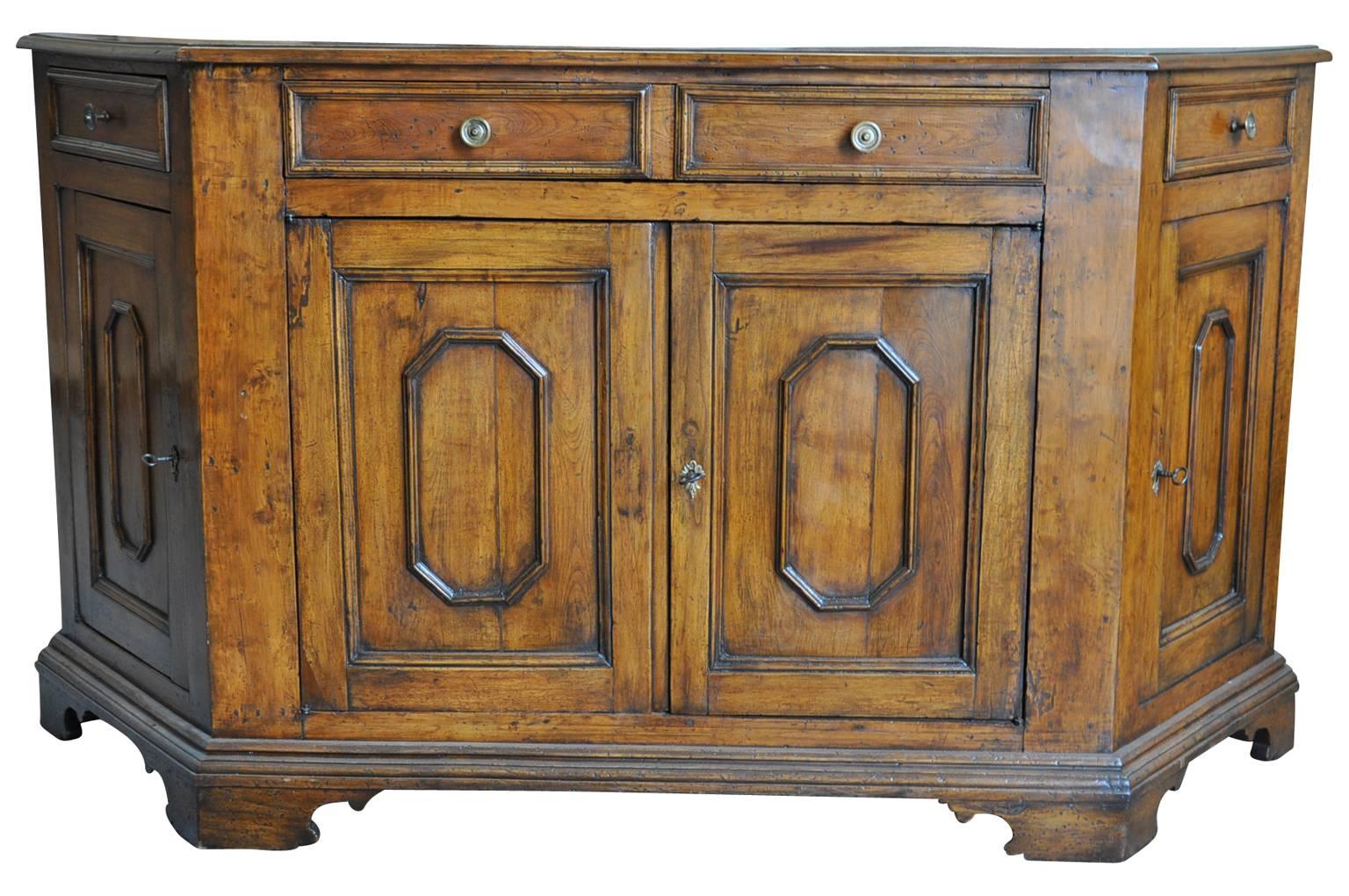 A very handsome mid-19th century credenza from Northern Italy. Wonderfully constructed from walnut with four doors and four drawers raised on bracket feet. The patina is very rich and luminous.