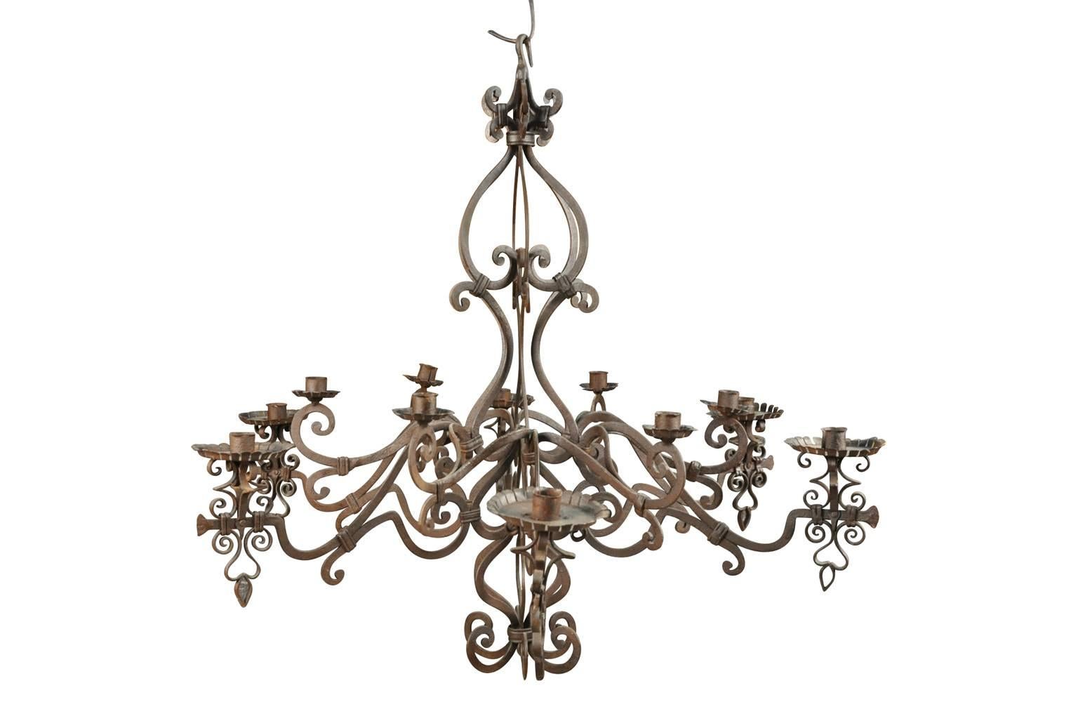 A terrific pair of forged iron chandeliers from Northern Italy. The chandeliers may be sold as a pair or individually. The price for the piece is $4900.
